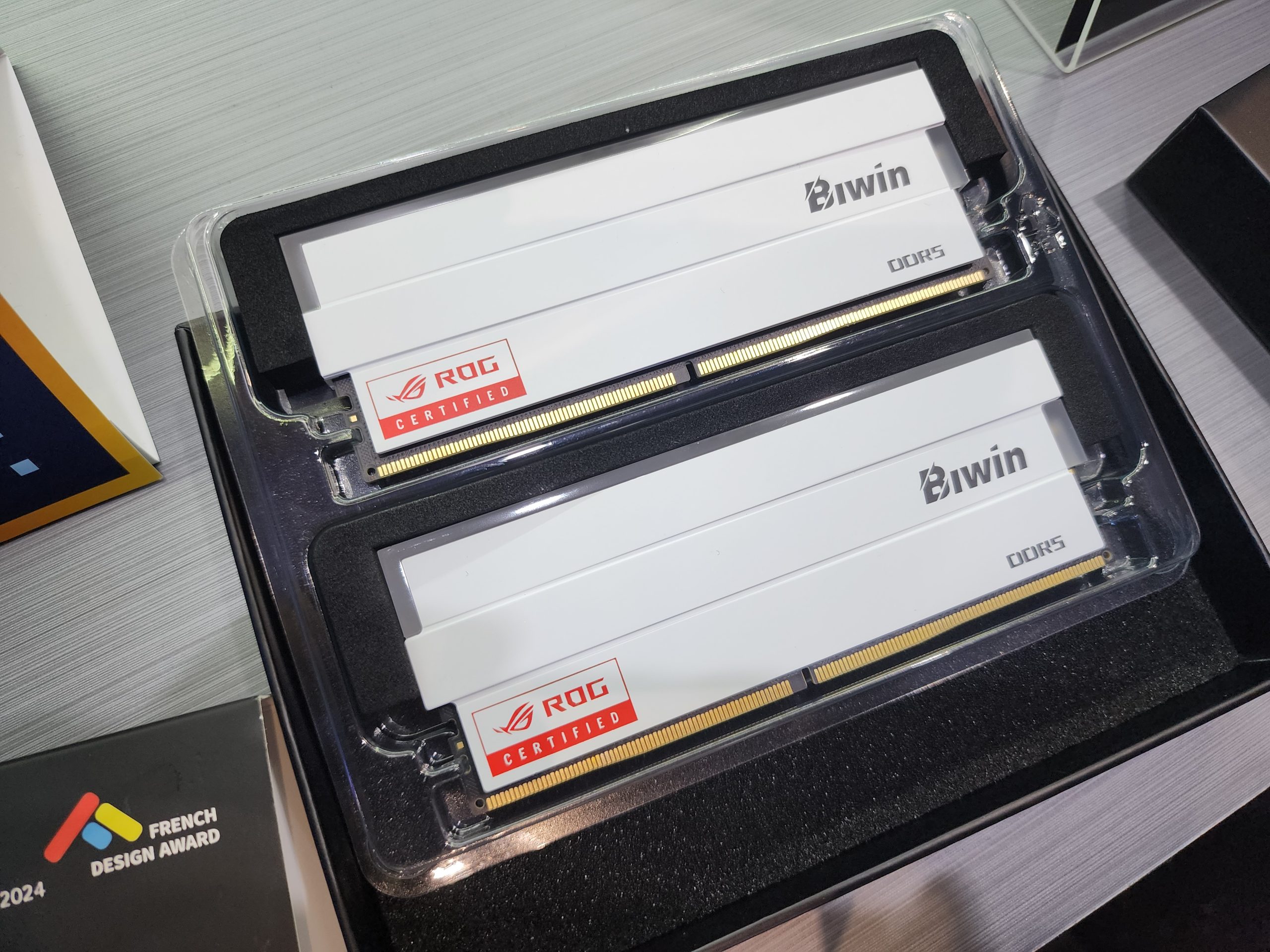 Two Biwin DDR5 RAM sticks with 'ROG Certified' labels, displayed in packaging.
