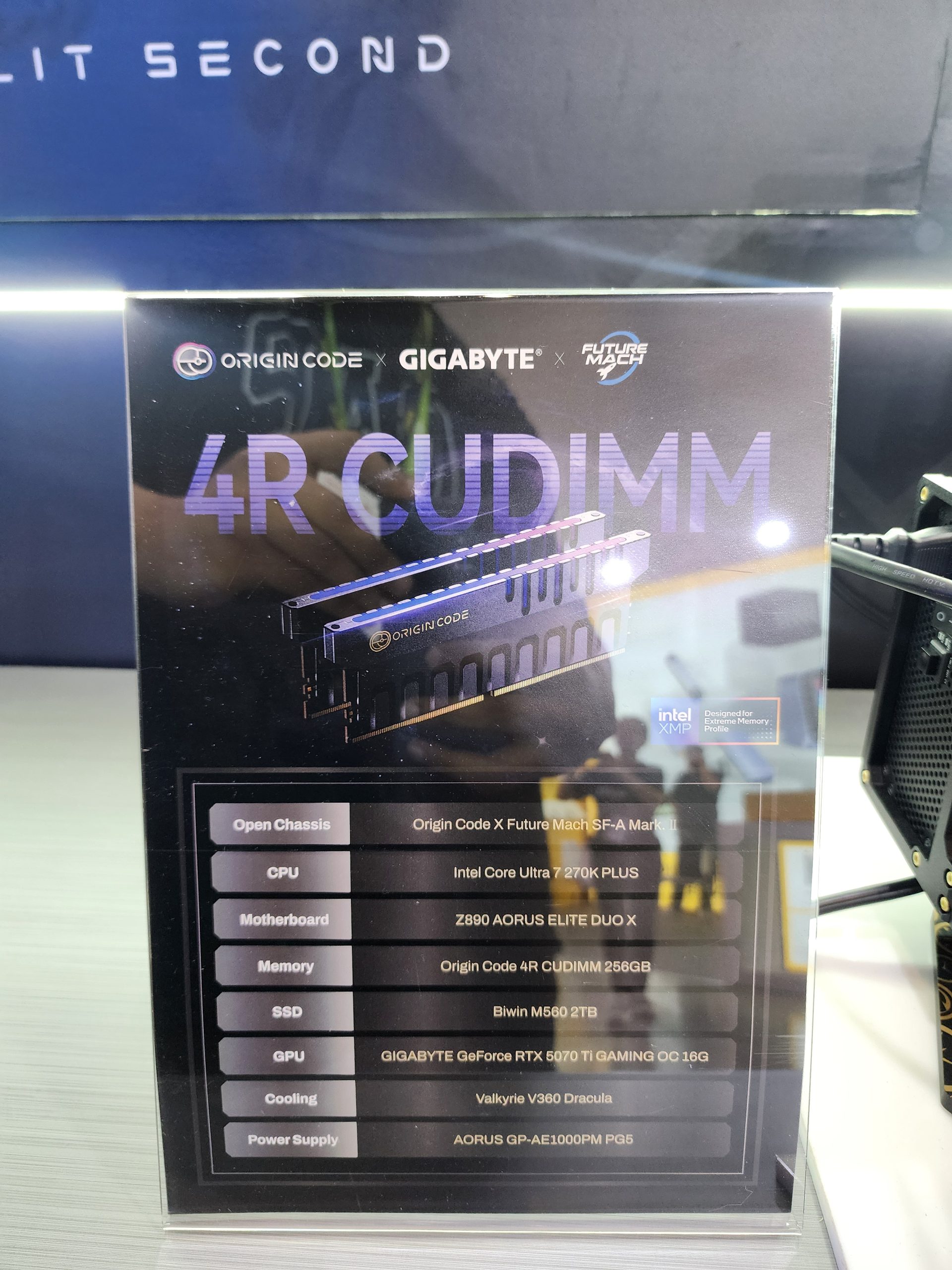 A display featuring specifications for a build including an Intel Core Ultra 7 270K PLUS CPU, Z890 AORUS ELITE DUO X motherboard, Origin Code 4R CUDIMM 256GB memory, Biwin M560 2TB SSD, GIGABYTE GeForce RTX 5070 Ti GAMING OC 16G GPU, Valkyrie V360 Dracula cooling, and AORUS GP-AE1000PM PG5 power supply.