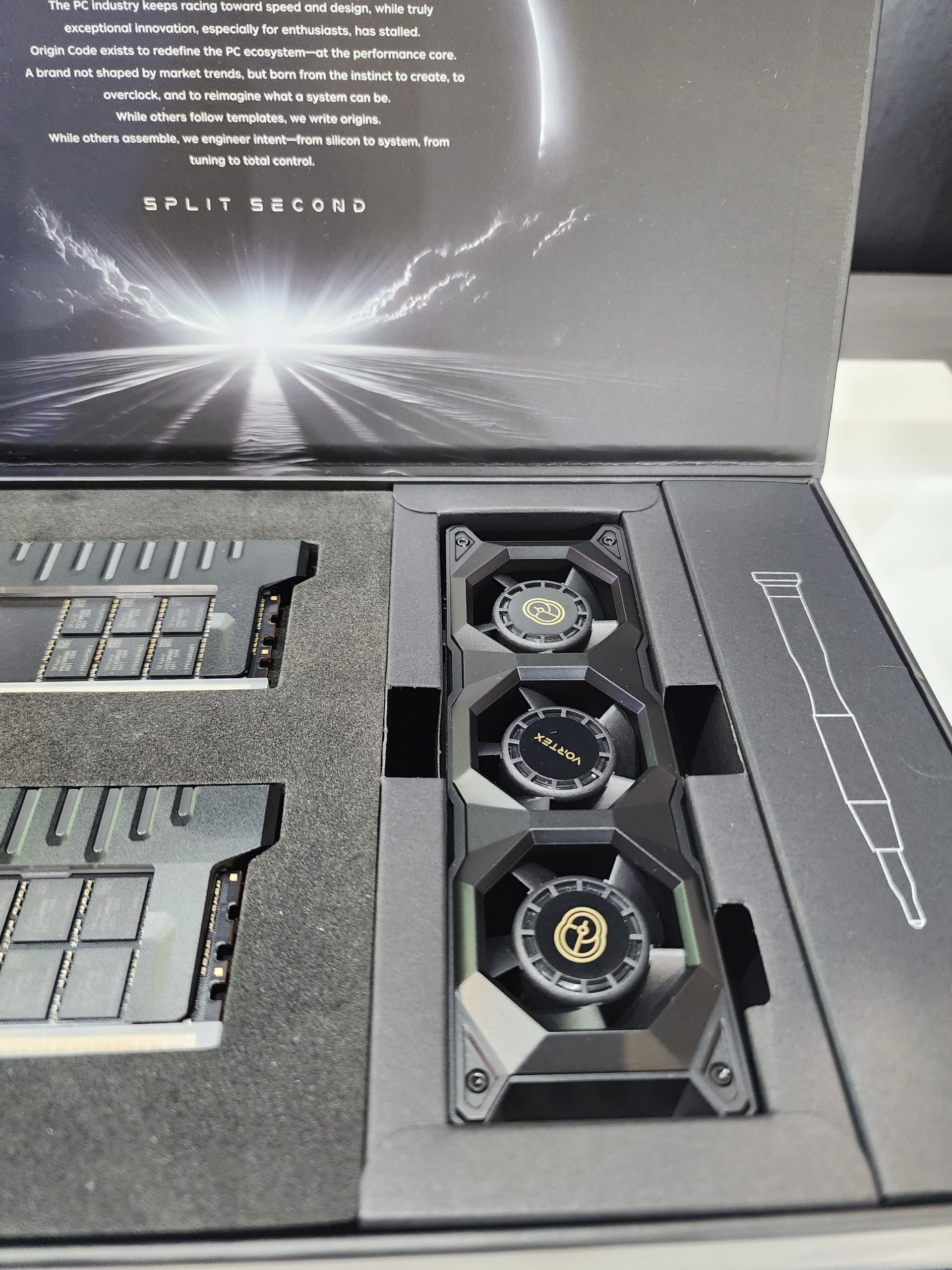 The packaging contains two unbranded graphics cards and a cooling system with 'Vortex' labeled fans next to a stylized design and the text 'SPLIT SECOND.'
