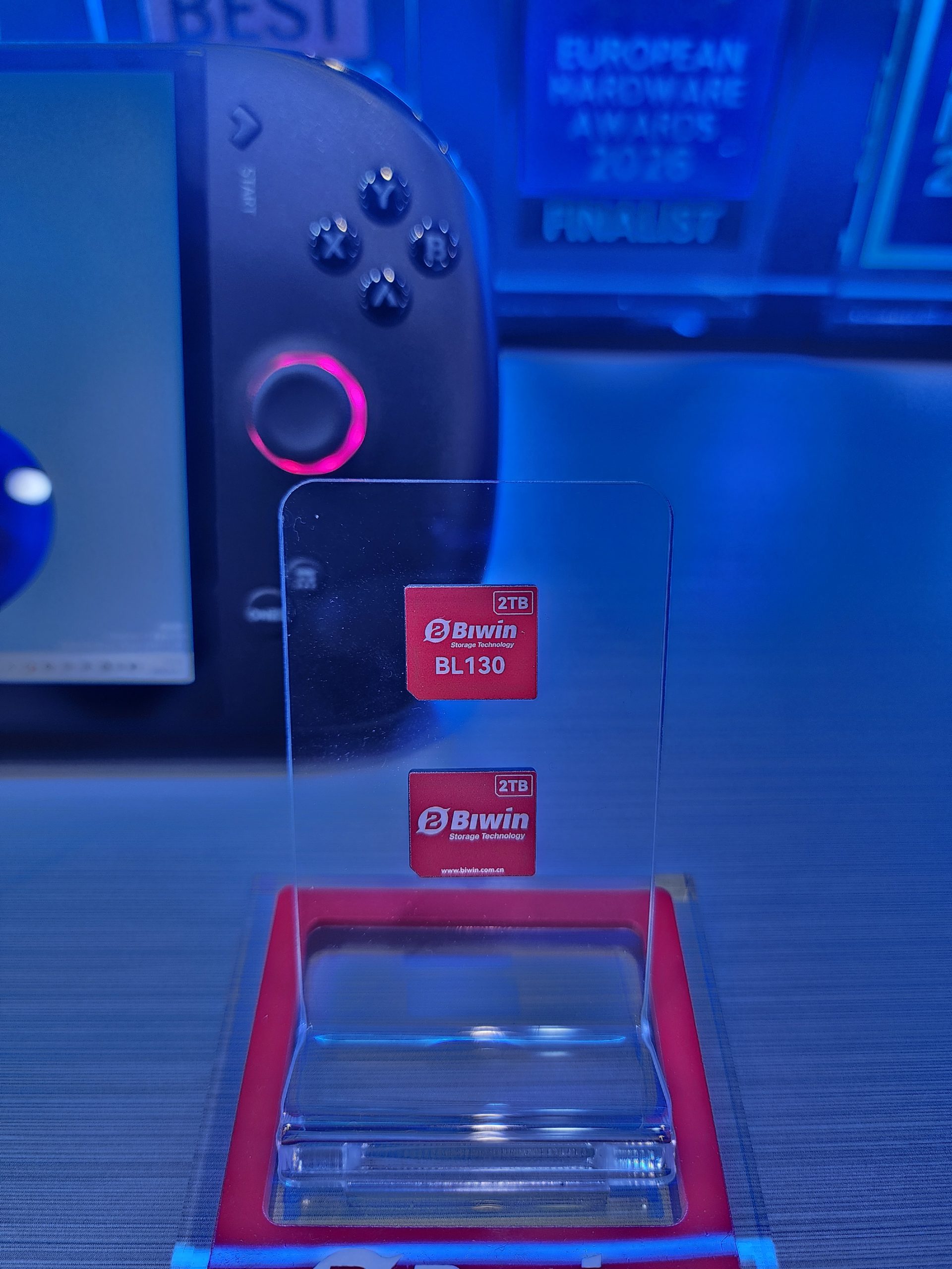 A Biwin BL130 2TB SSD is displayed in front of a gaming device with a joystick and buttons.