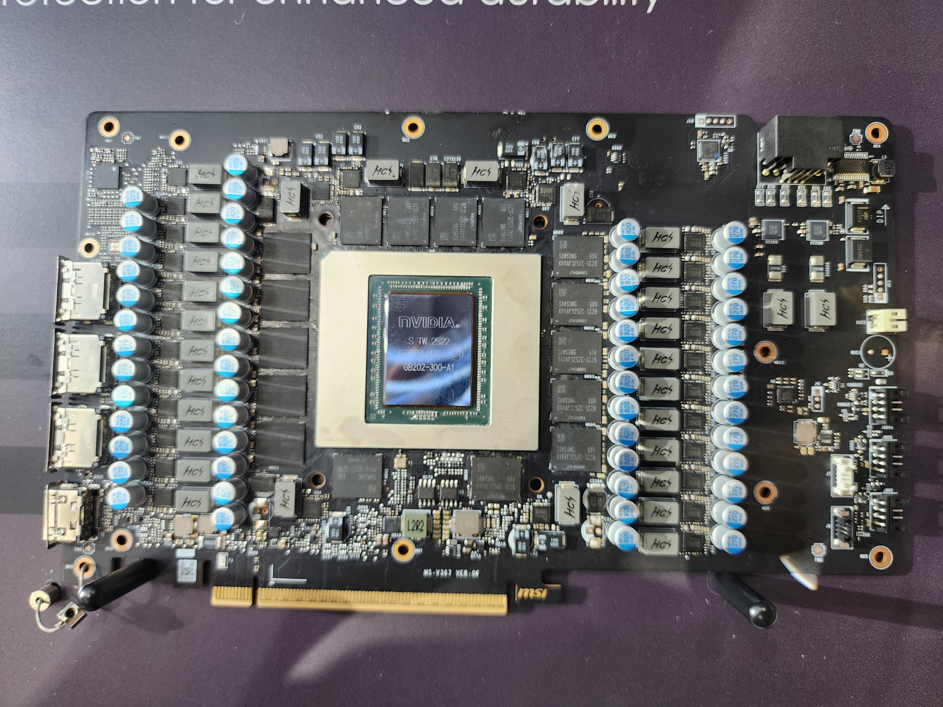 A close-up view of a graphics card featuring an NVIDIA chip labeled 'NVIDIA 68202-300-A1' on a dark circuit board with numerous capacitors and connectors.