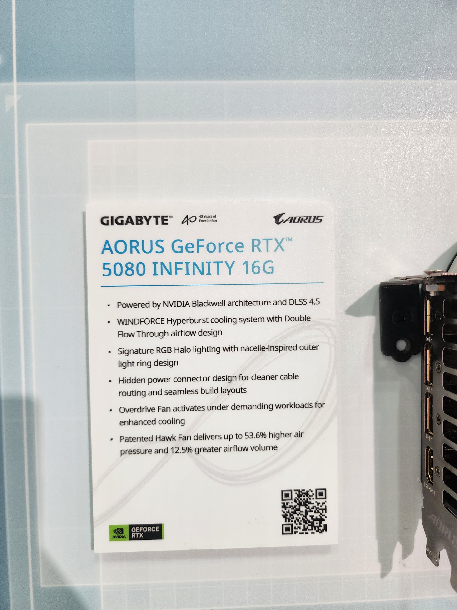 A sign details the features of the Gigabyte AORUS GeForce RTX 5080 INFINITY 16G, including 'NVIDIA Blackwell architecture and DLSS 4.5' and 'Patented Hawk Fan delivers up to 53.6% higher air pressure and 12.5% greater airflow volume.'