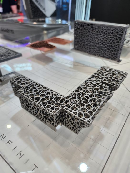 A display of porous, metallic heatsinks from Gigabyte showcased at an event, with a focus on intricate design.