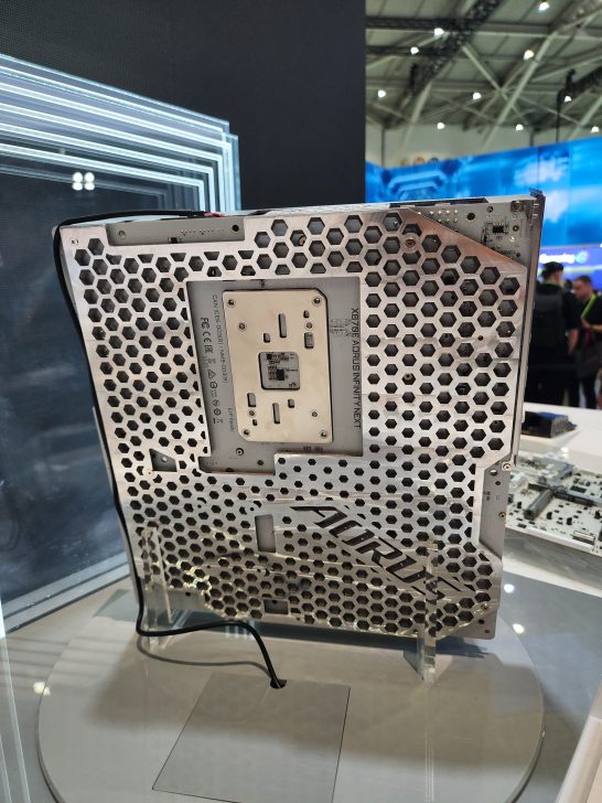 A Gigabyte Aorus X8T6E chassis with a honeycomb design is displayed at a tech event.