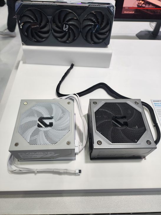 Two Gigabyte Gaming power supplies with visible wattages of '850W' and '1000W' displayed on a white surface, with a Gigabyte graphics card visible in the background.