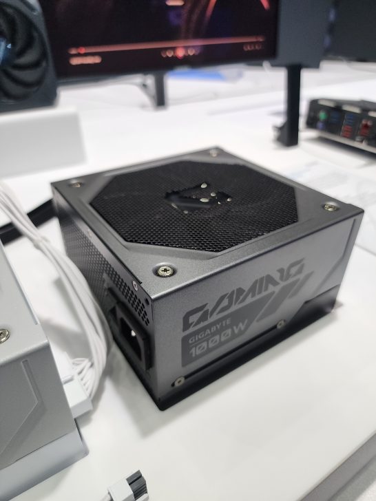A Gigabyte 1000W gaming power supply unit is displayed on a table.