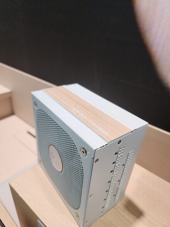 A white MSI power supply unit with a wood-textured top, labeled 'MEG Ai1300P'.