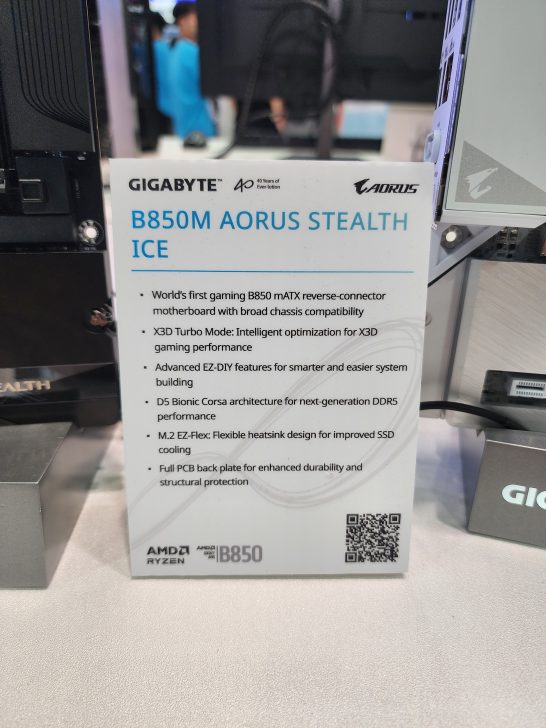 A sign displays the Gigabyte B850M Aorus Stealth Ice motherboard specifications featuring X3D Turbo Mode and D5 Bionic Corsa architecture.