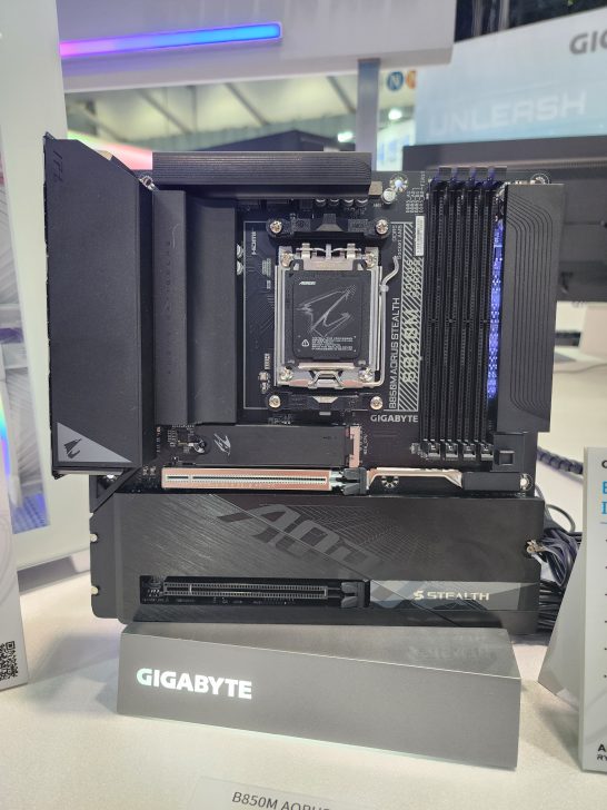 The Gigabyte B850M AORUS STEALTH motherboard is displayed vertically, showcasing its design and DDR5 slots.