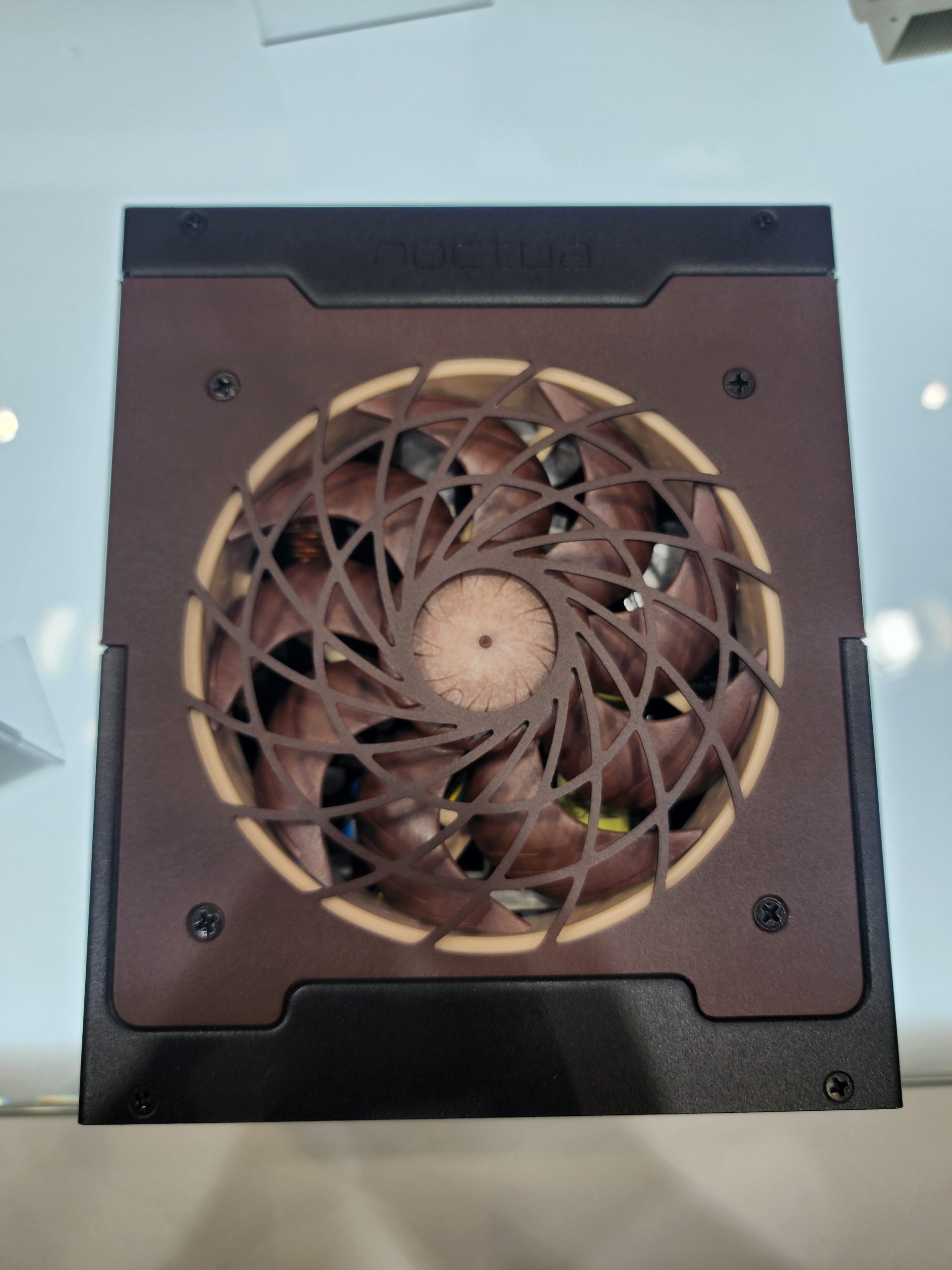 Noctua power supply unit with a distinctive brown fan design viewed from above.