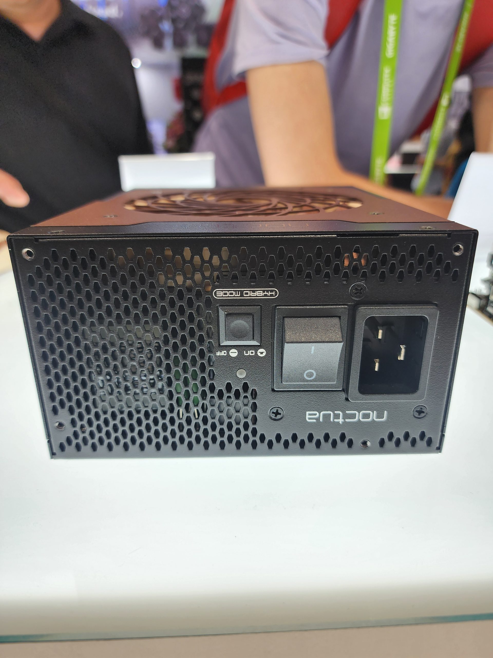 The image shows the back panel of a Noctua power supply unit featuring a 'Hybrid Mode' switch, an on/off switch, and a power input socket.