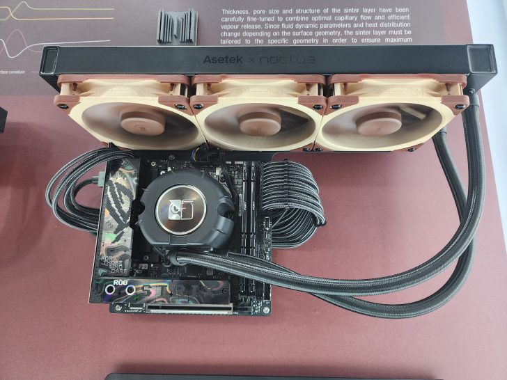 An Asetek x Noctua cooling system is installed on an ASUS ROG motherboard with visible Noctua fans and braided cables.