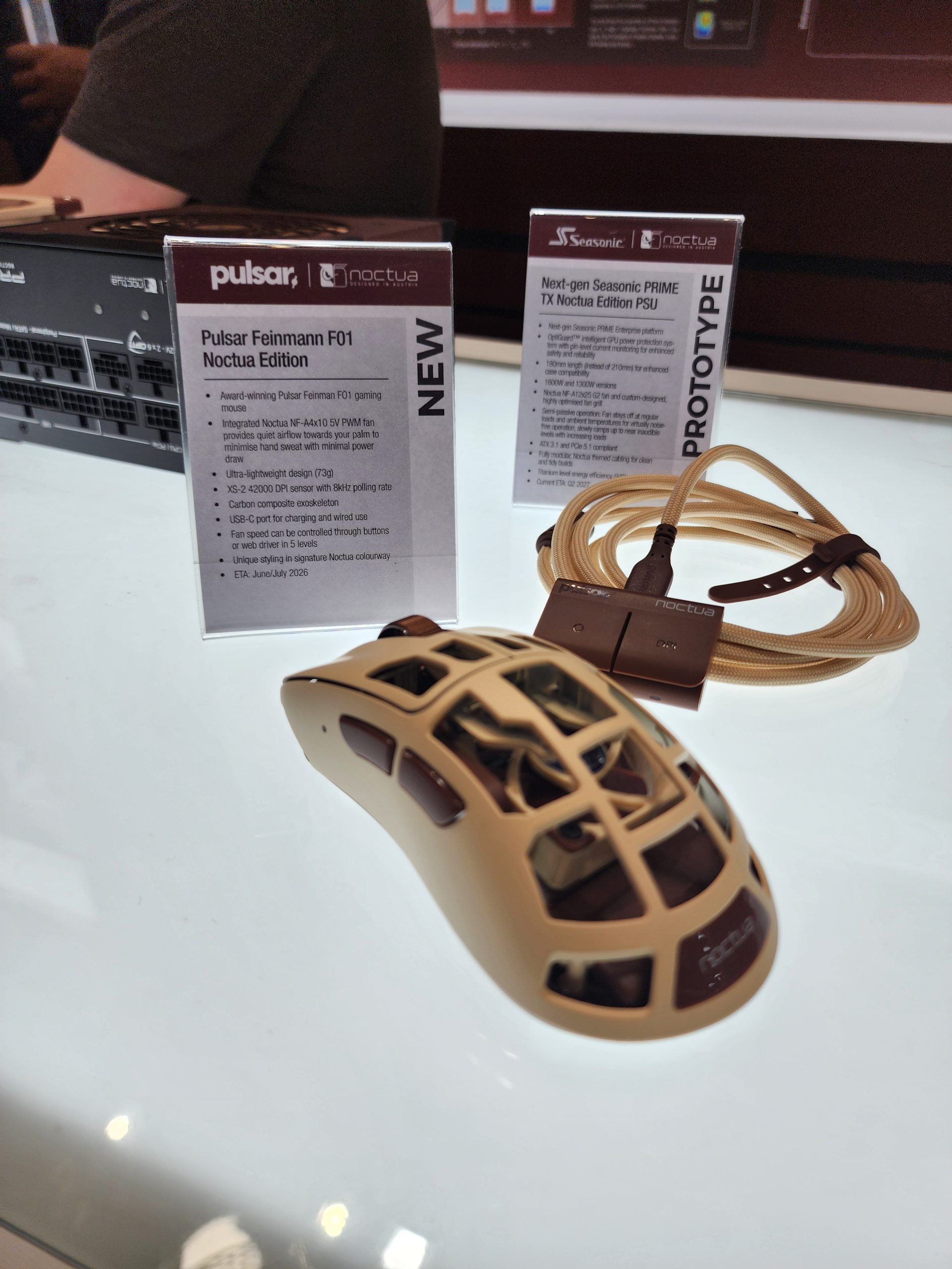 A Pulsar Feinmann F01 Noctua Edition gaming mouse with a lattice design is displayed next to informational cards detailing the product's features and specifications.