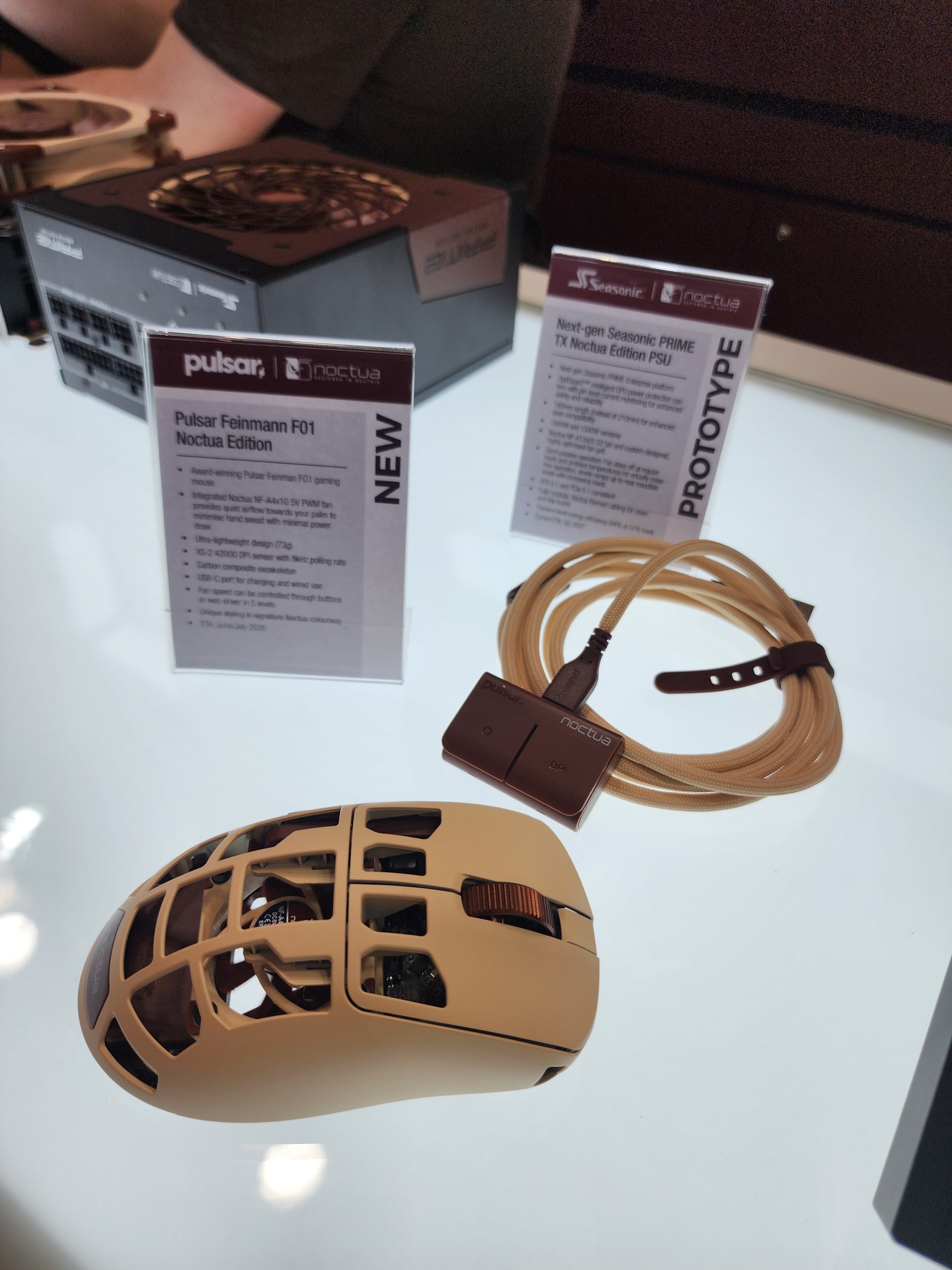 A display features a Pulsar Feinman F01 Noctua Edition gaming mouse and a next-gen Seasonic PRIME TX Noctua Edition PSU prototype.