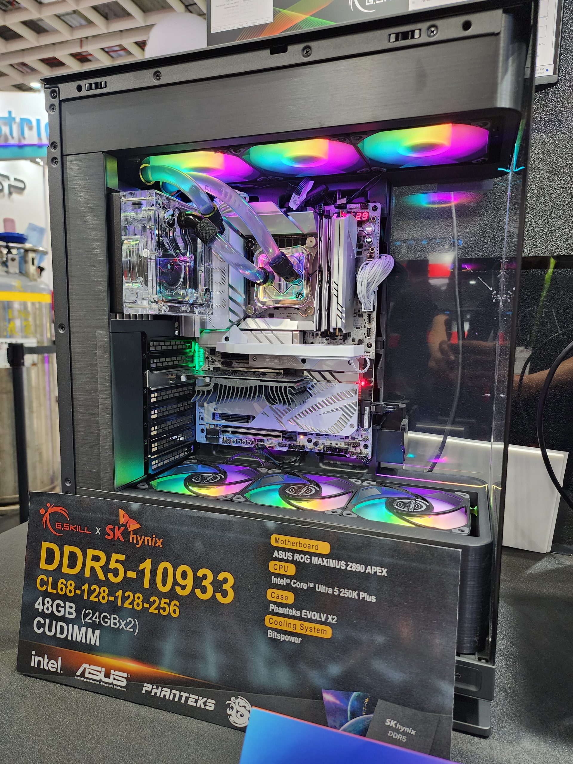A custom desktop PC with RGB cooling features a G.SKILL x SK hynix DDR5-10933 memory, ASUS ROG Maximus Z890 APEX motherboard, Intel Core Ultra 5 250K Plus CPU, and Phanteks EVOLV X2 case.
