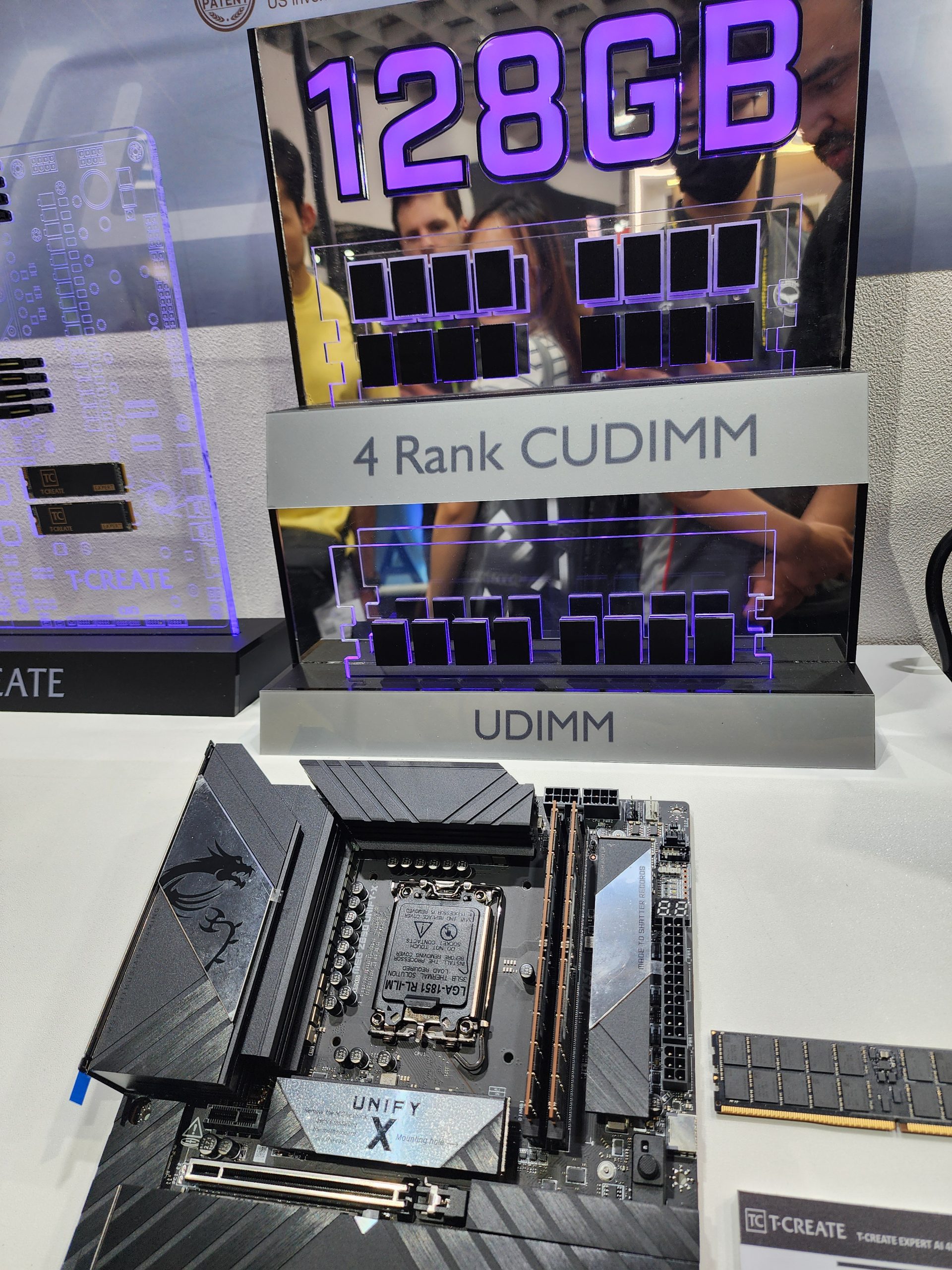 A display showcases '128GB' 4 Rank CUDIMM memory modules next to a motherboard labeled 'UNIFY X' from T-Create.