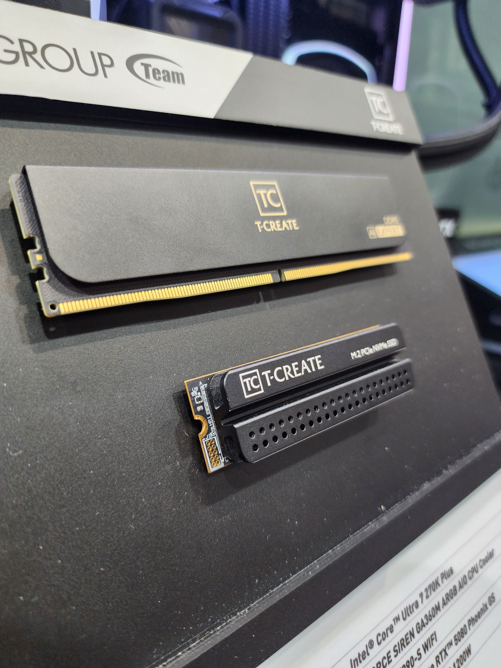 A display featuring the Team Group T-CREATE DDR5 memory module and M.2 PCIe NVMe SSD.