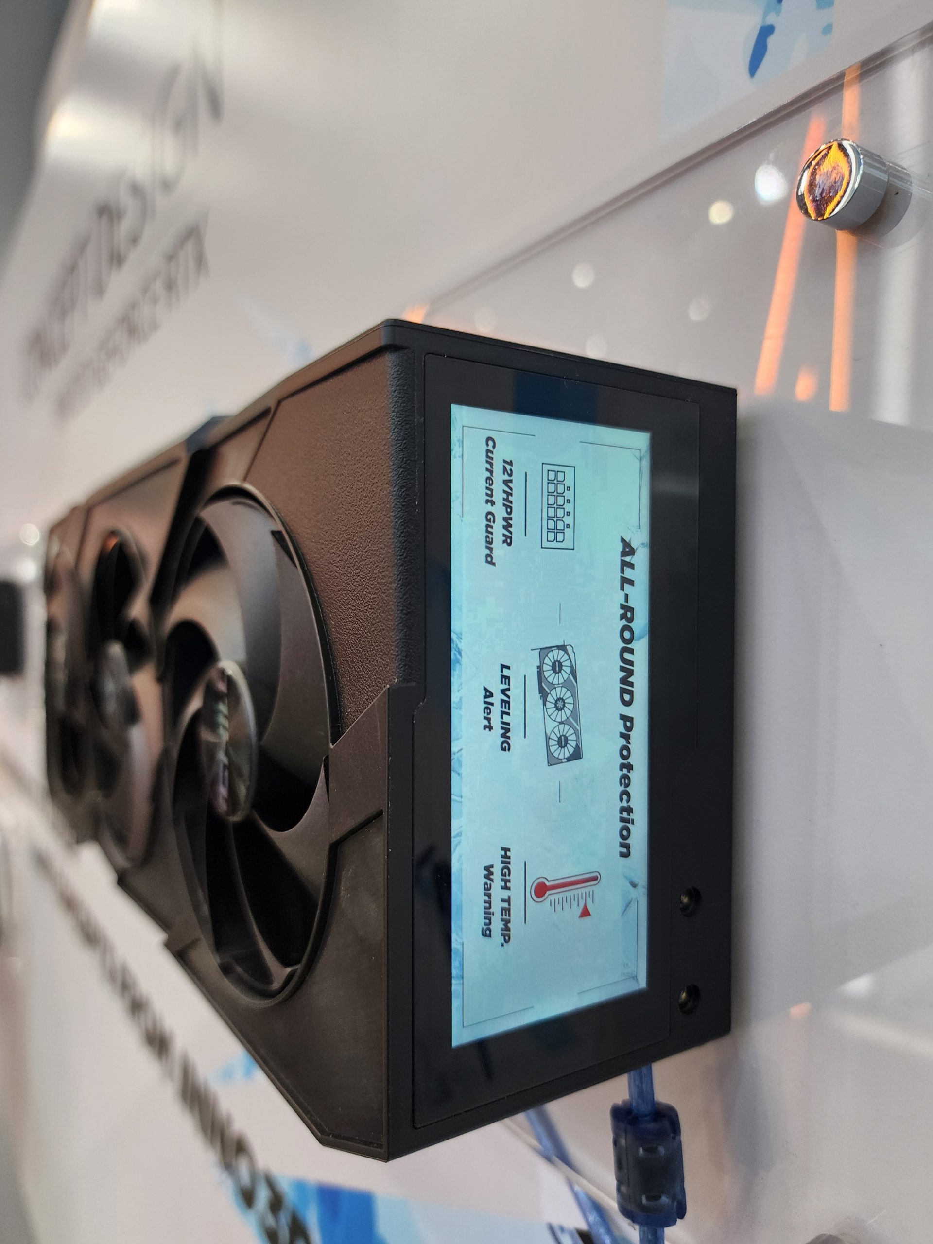 A Palit GeForce RTX graphics card with a display screen showing alerts for '12VHPWR Current Guard', 'LEVELING Alert', and 'HIGH TEMP Warning'.