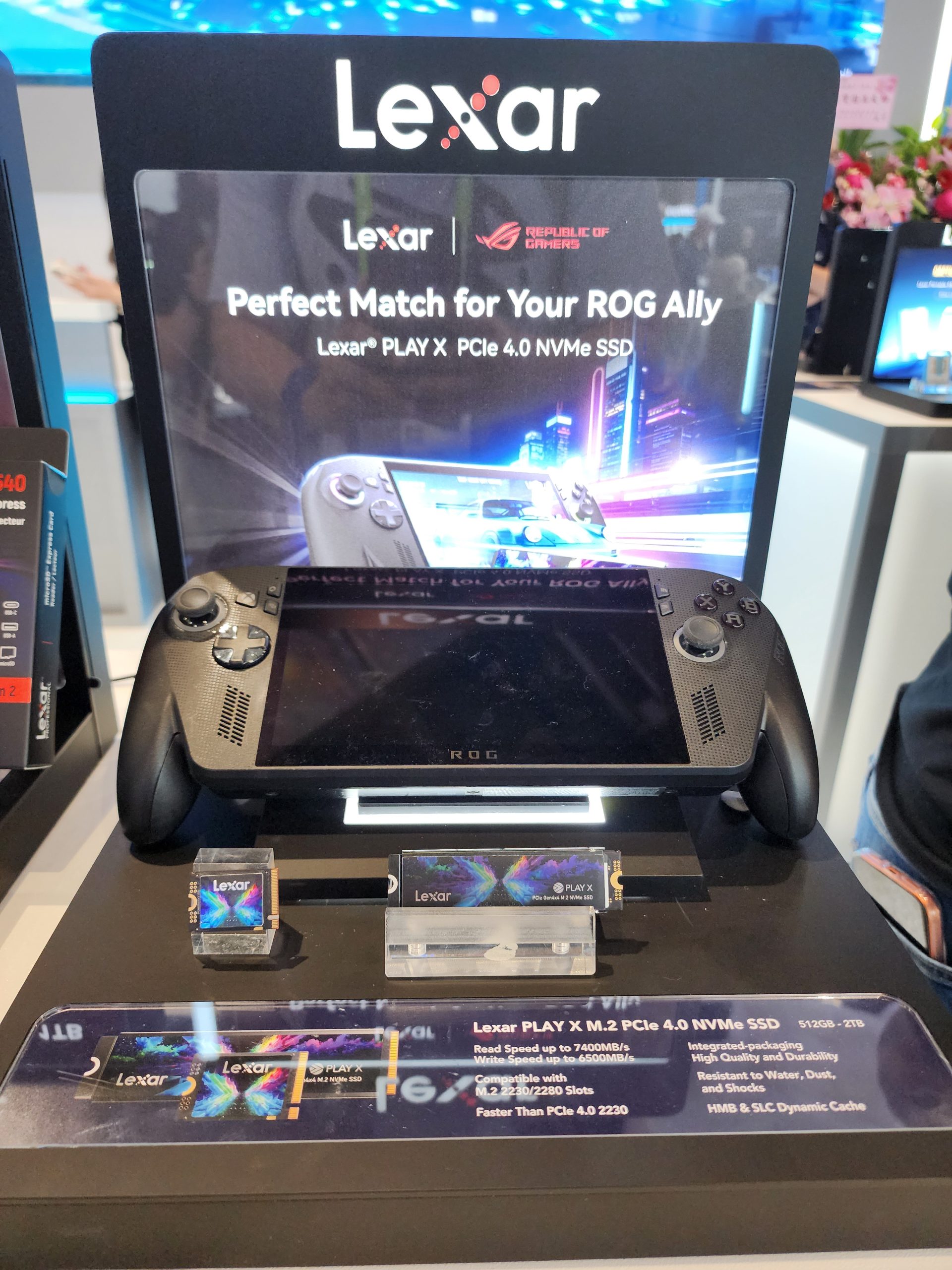A display showcases the Lexar PLAY X PCIe 4.0 NVMe SSD with packaging indicating compatibility with ROG Ally, featuring read speeds up to 7400MB/s, and storage options from 512GB to 2TB.
