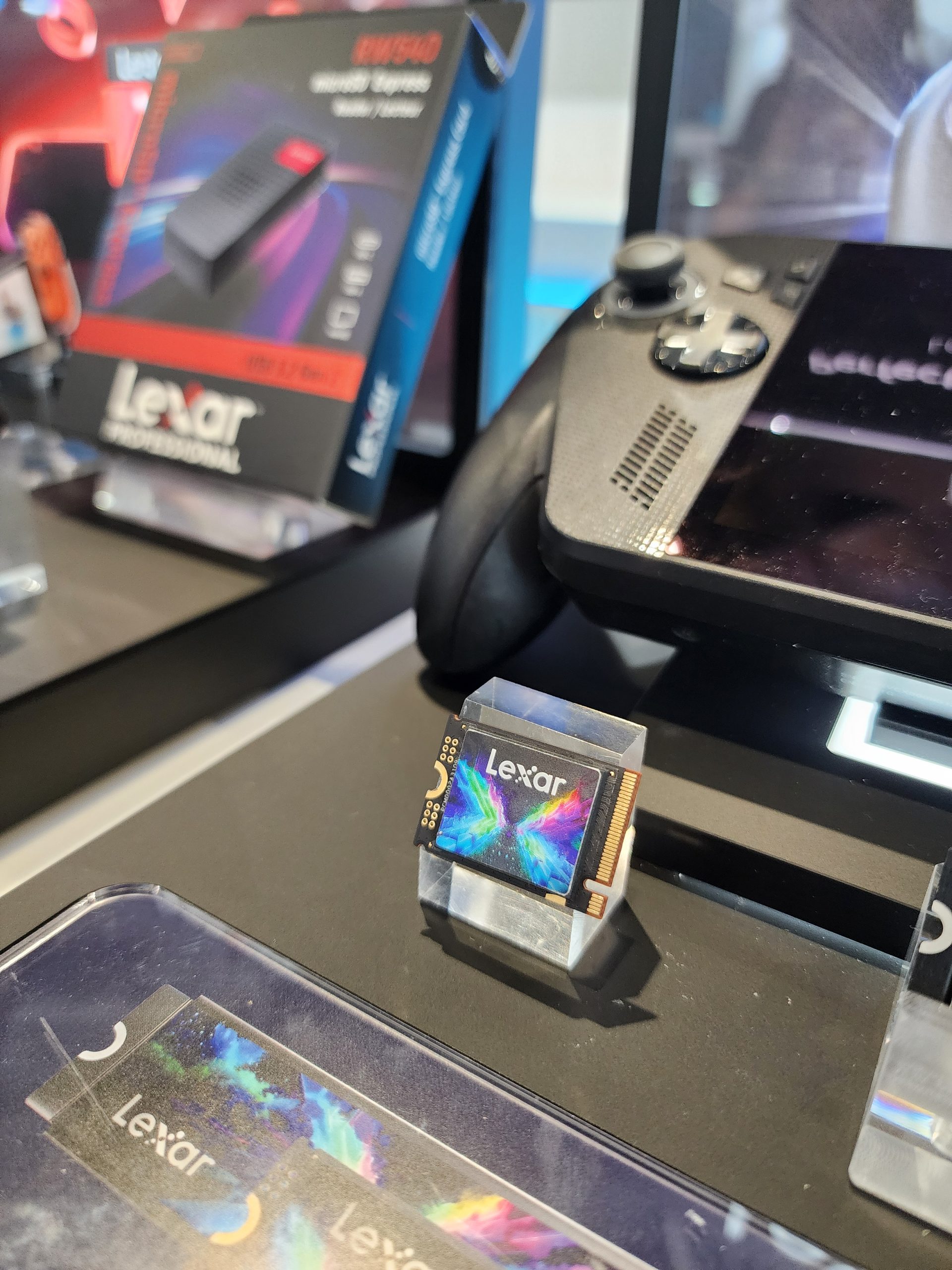 A Lexar Professional NM940 storage device is displayed next to a Lexar-branded console with visible branding.
