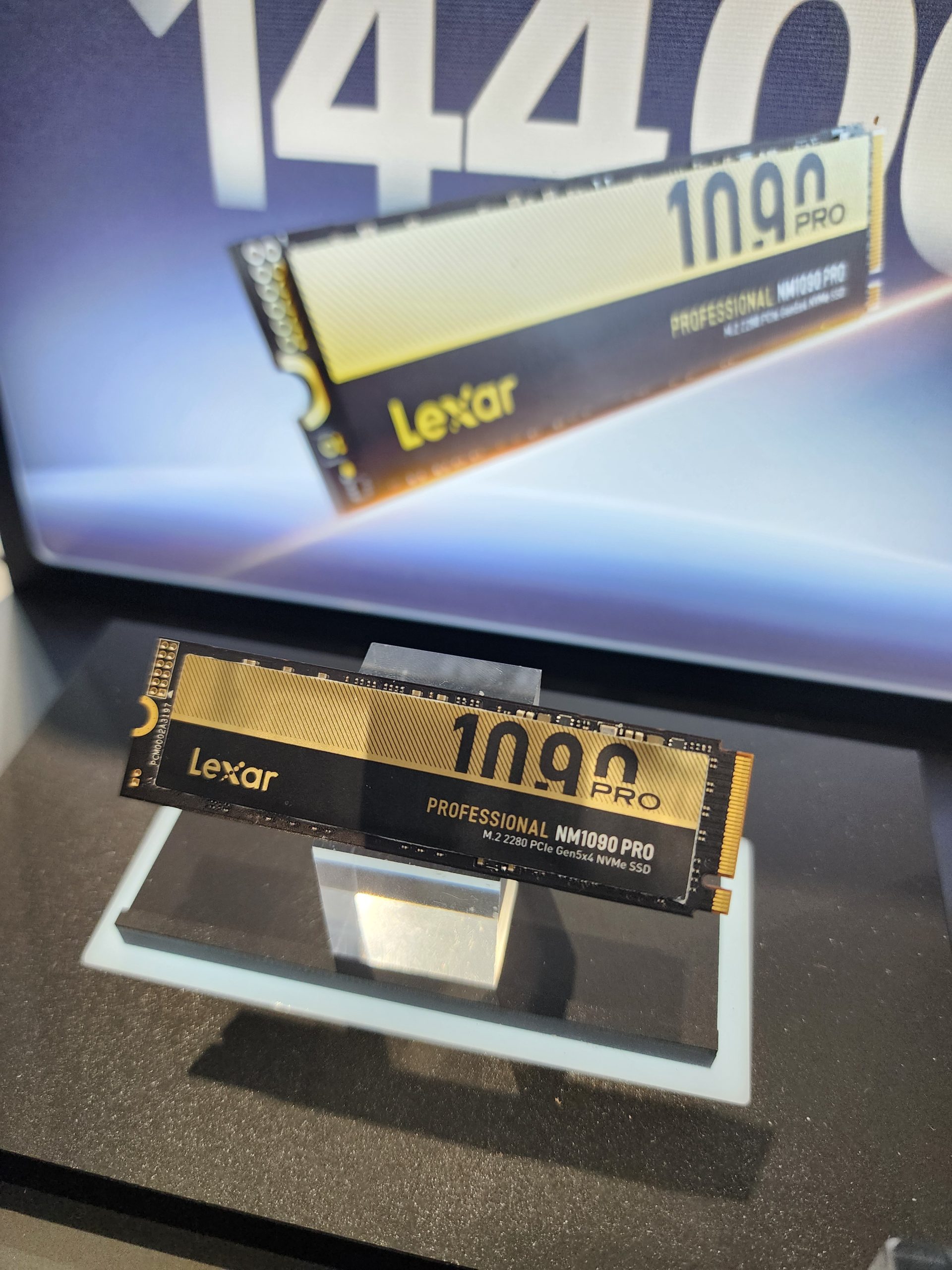 A Lexar Professional NM1090 Pro M.2 2280 PCIe Gen5x4 NVMe SSD is displayed on a stand with branding and model information visible.