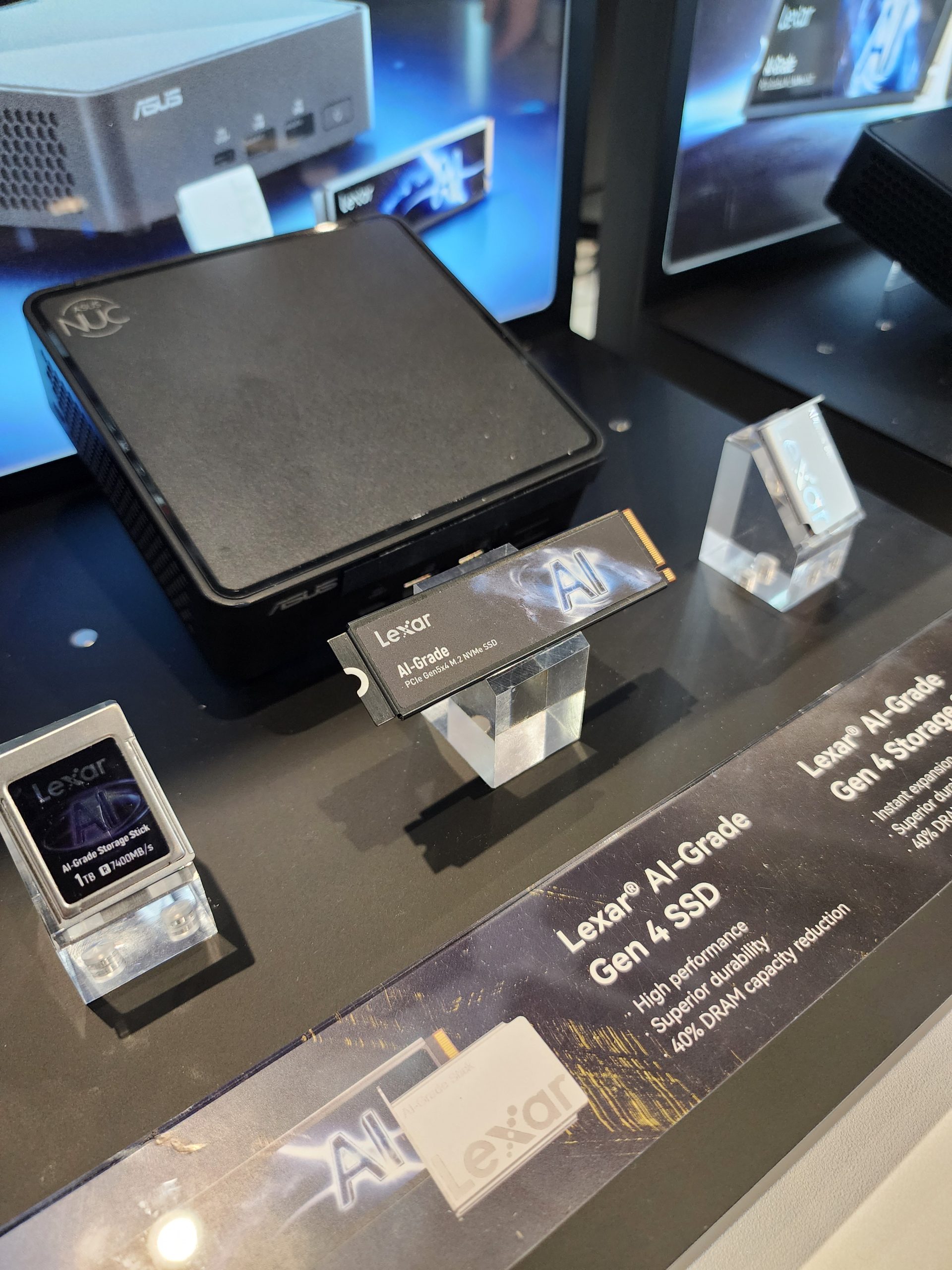 A display of Lexar AI-Grade Gen 4 SSD featuring the text 'Lexar AI-Grade Gen 4 SSD' alongside an ASUS NUC device.