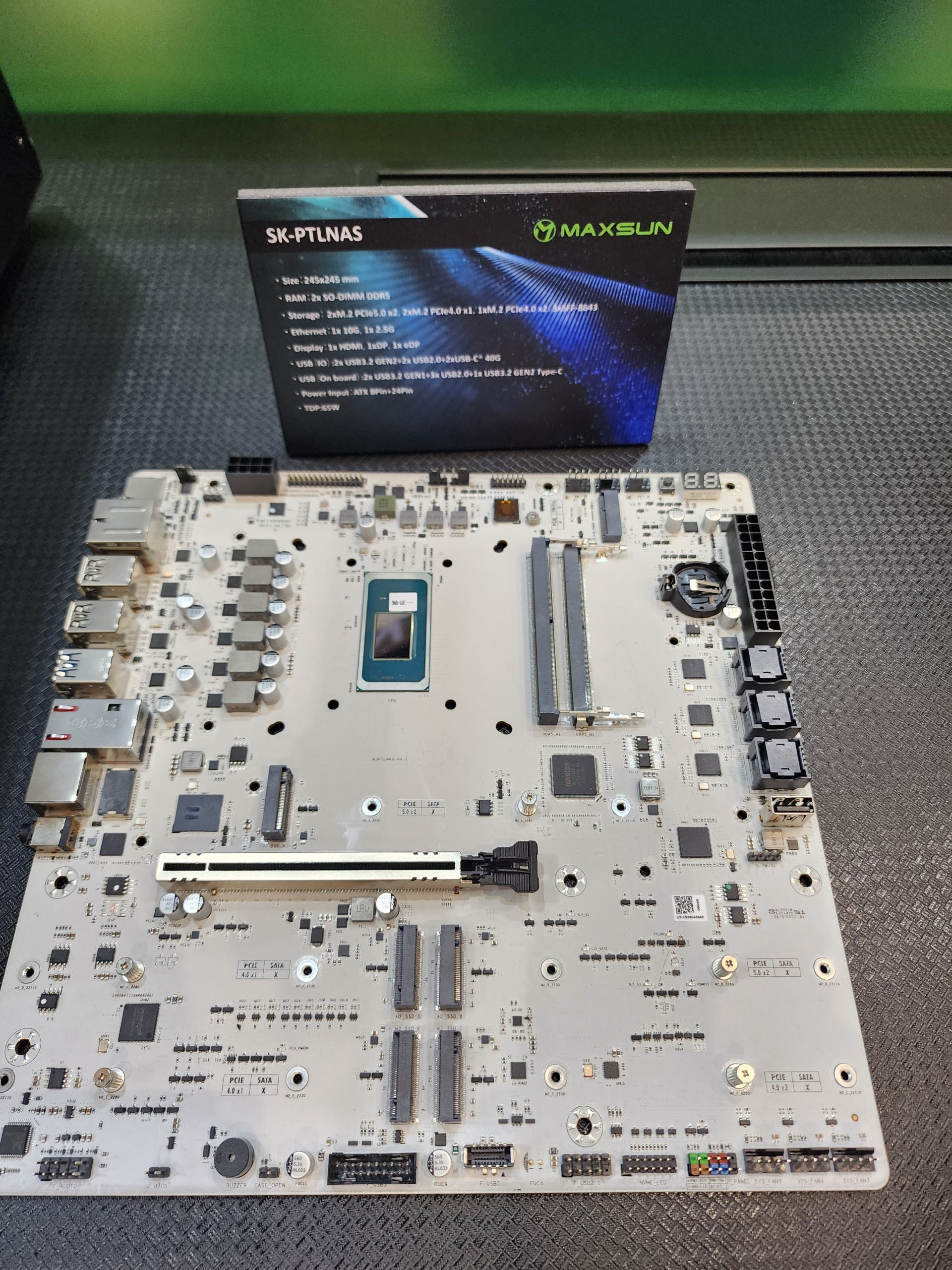 A Maxsun SK-PTLNAS motherboard is displayed with a specification card detailing features such as size, RAM, storage, and connectivity options.