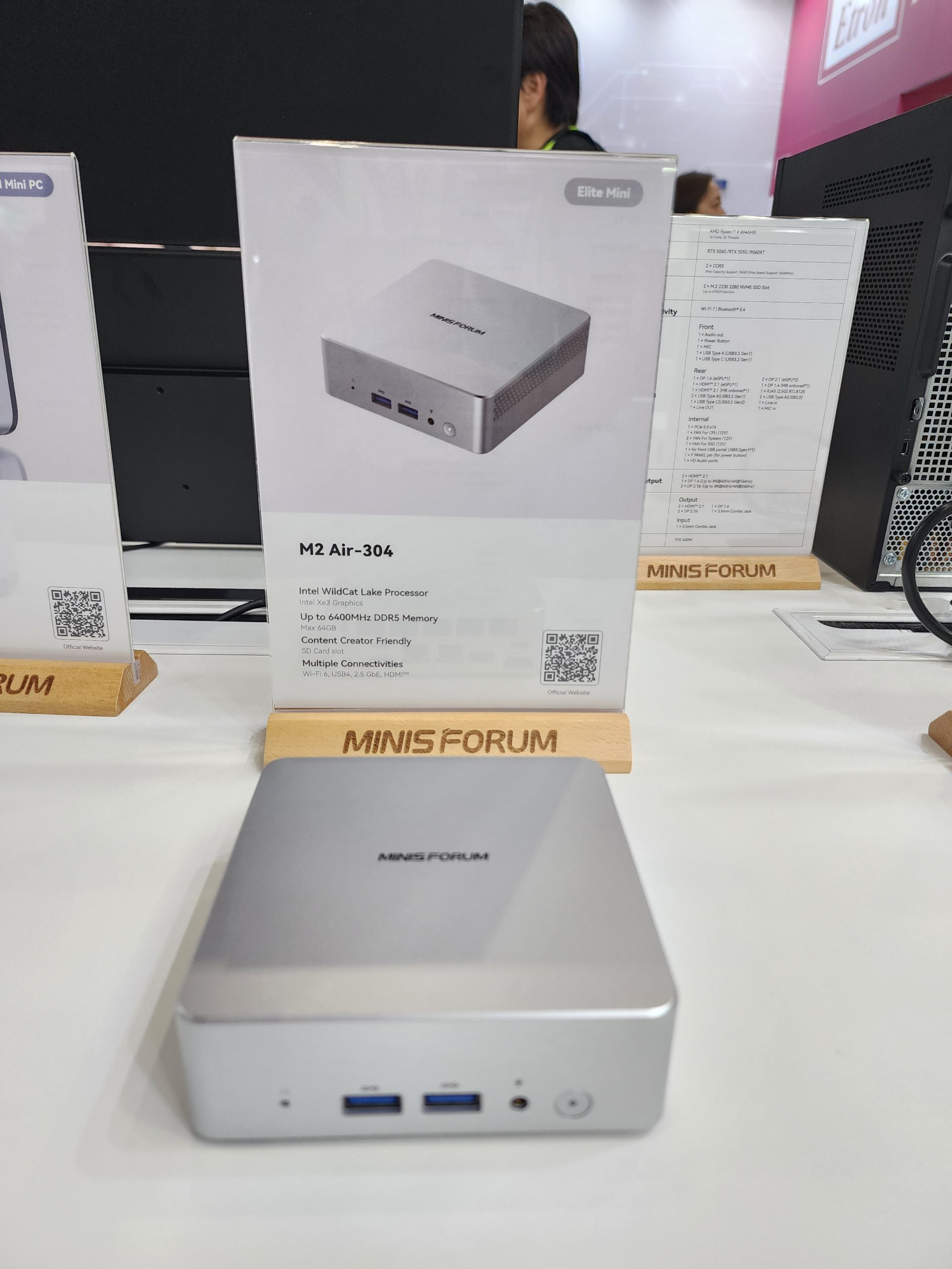 A MinisForum Elite Mini PC model M2 Air-304 is displayed with features including an Intel WildCat Lake processor, Intel HD Graphics, and support for up to 6400MHz DDR5 memory.