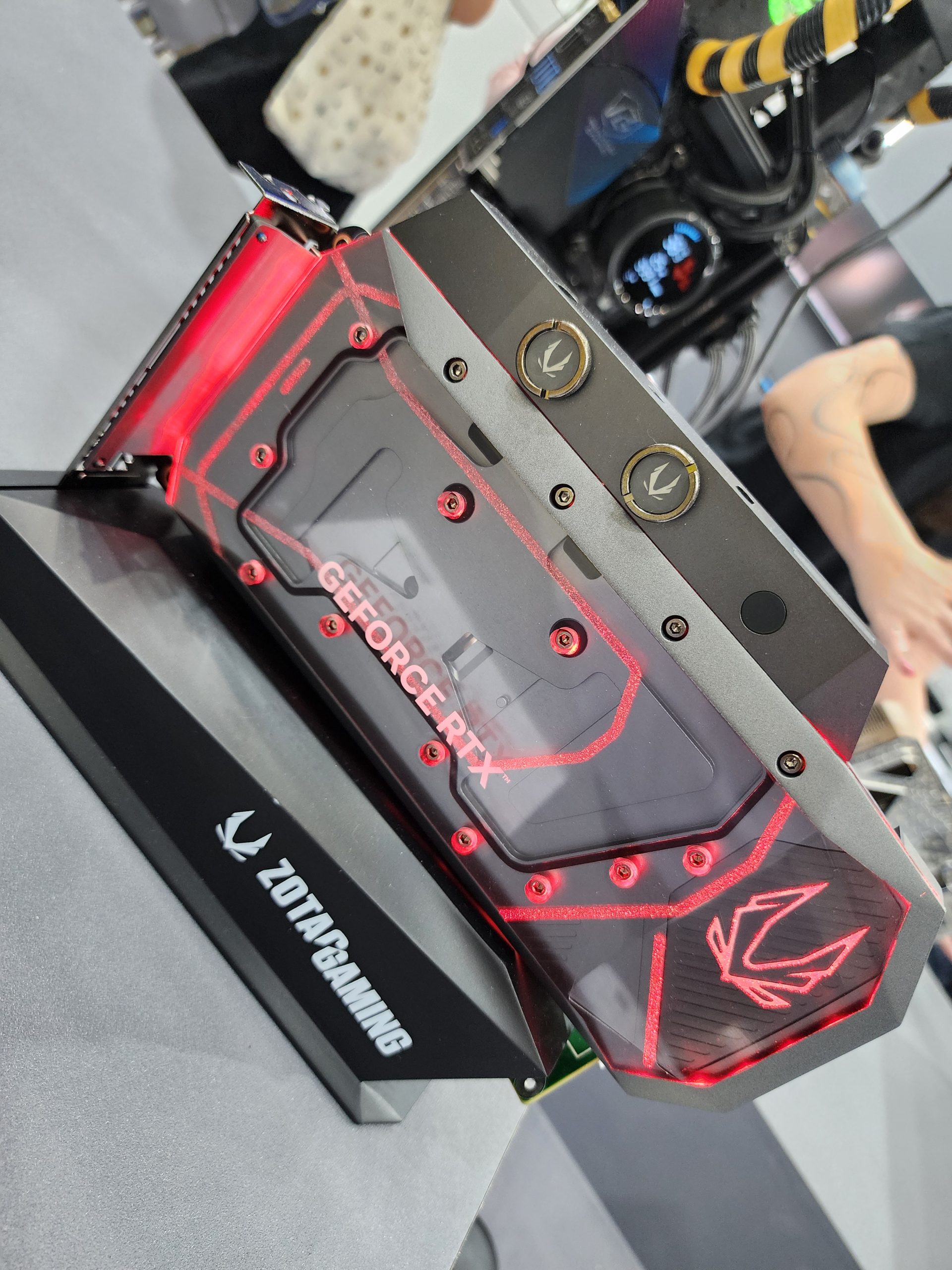 A ZOTAC GAMING graphics card with 'GEFORCE RTX' branding is showcased with a custom red and black design.