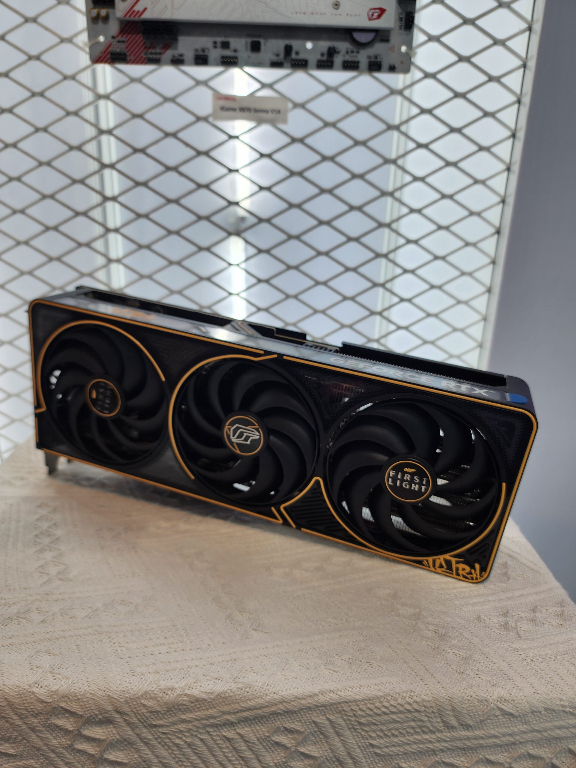 The image shows a Colorful GeForce RTX 4090 graphics card with a custom design featuring the text 'First Light' on its cooling fans.