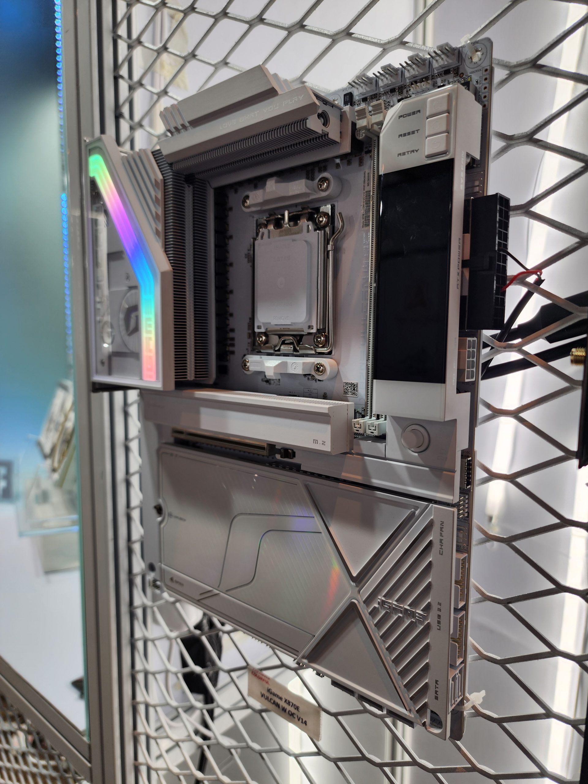 An ASUS prime X670E Valkyrie motherboard with RGB lighting is mounted vertically on a mesh display.
