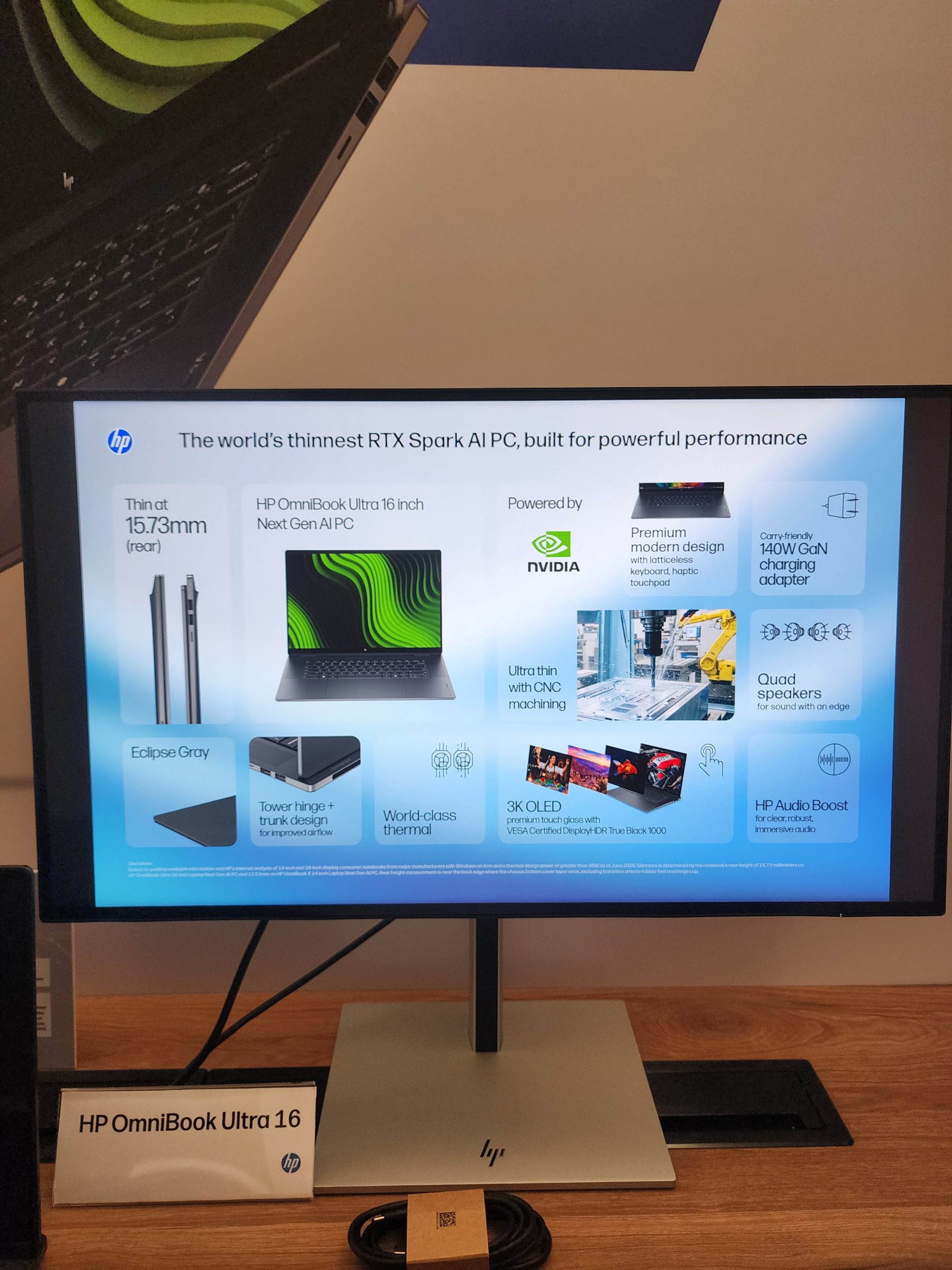 The display shows a presentation slide titled The world's thinnest RTX Spark AI PC featuring the HP OmniBook Ultra 16, highlighting features like NVIDIA power, 3K OLED display, and 140W GaN charging adapter.