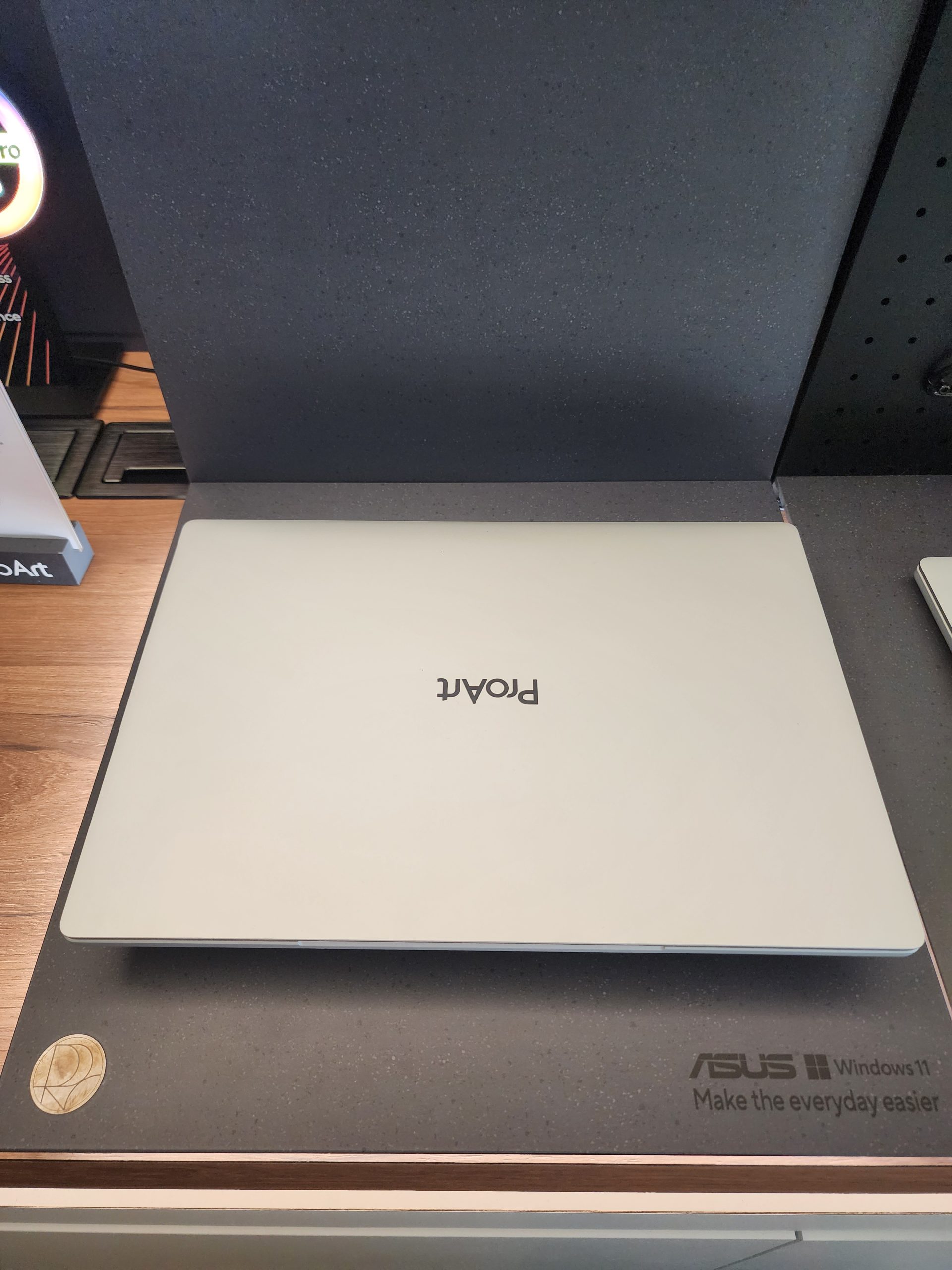 An ASUS laptop with the 'ProArt' logo on its lid, displayed on a surface featuring the 'ASUS Windows 11 Make the everyday easier' branding.