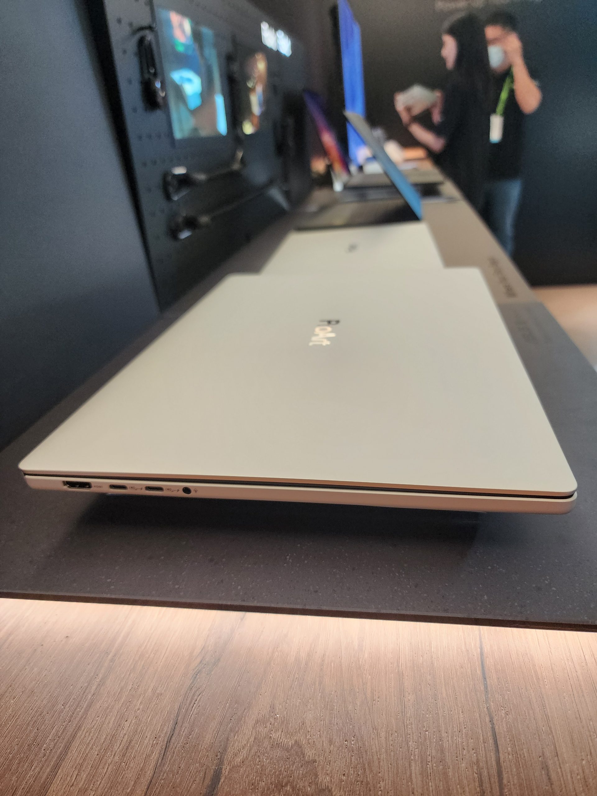 A Poof branded laptop is displayed on a table alongside other devices.