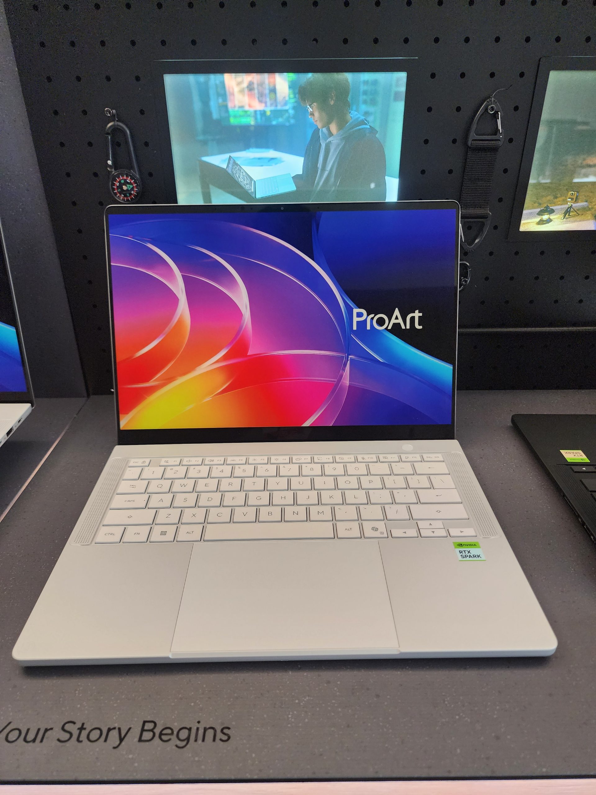 An ASUS ProArt laptop is displayed on a table, with a ProArt logo on the screen and 'RTX Studio' sticker on the palm rest.
