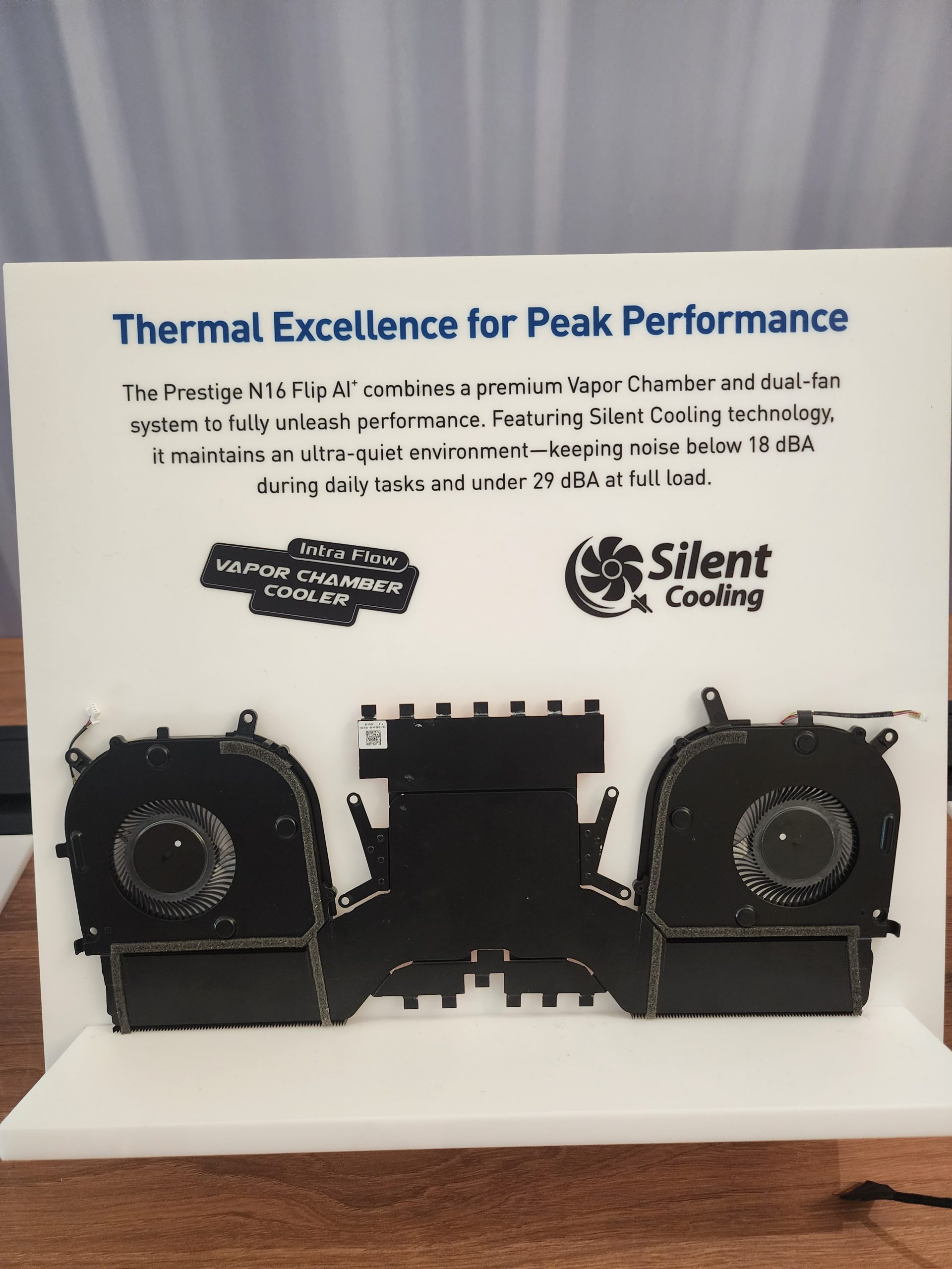 A display features the Prestige N16 Flip A1's dual-fan and vapor chamber cooling system with 'Thermal Excellence for Peak Performance' text and logos for 'Intra Flow Vapor Chamber Cooler' and 'Silent Cooling.'