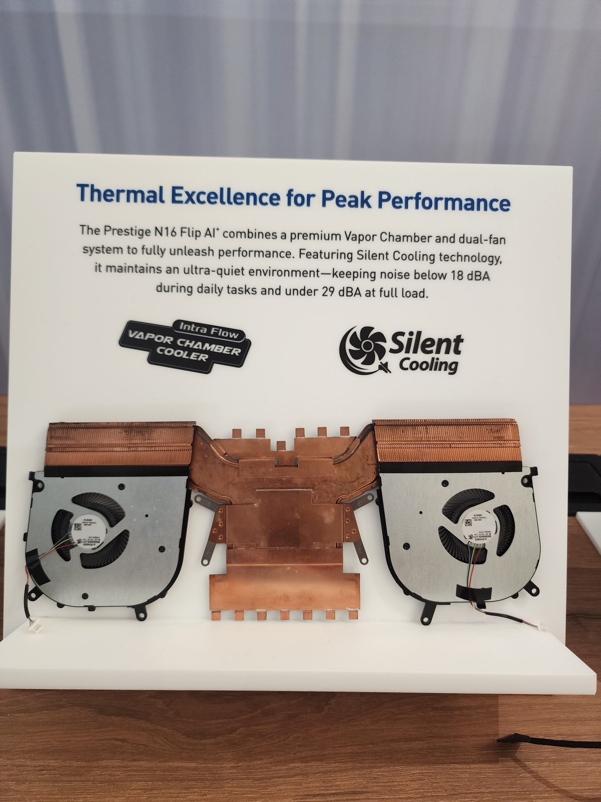 A display featuring the Prestige N16 Flip AI's vapor chamber cooler with dual fans highlights 'Thermal Excellence for Peak Performance' and mentions silent cooling technology.