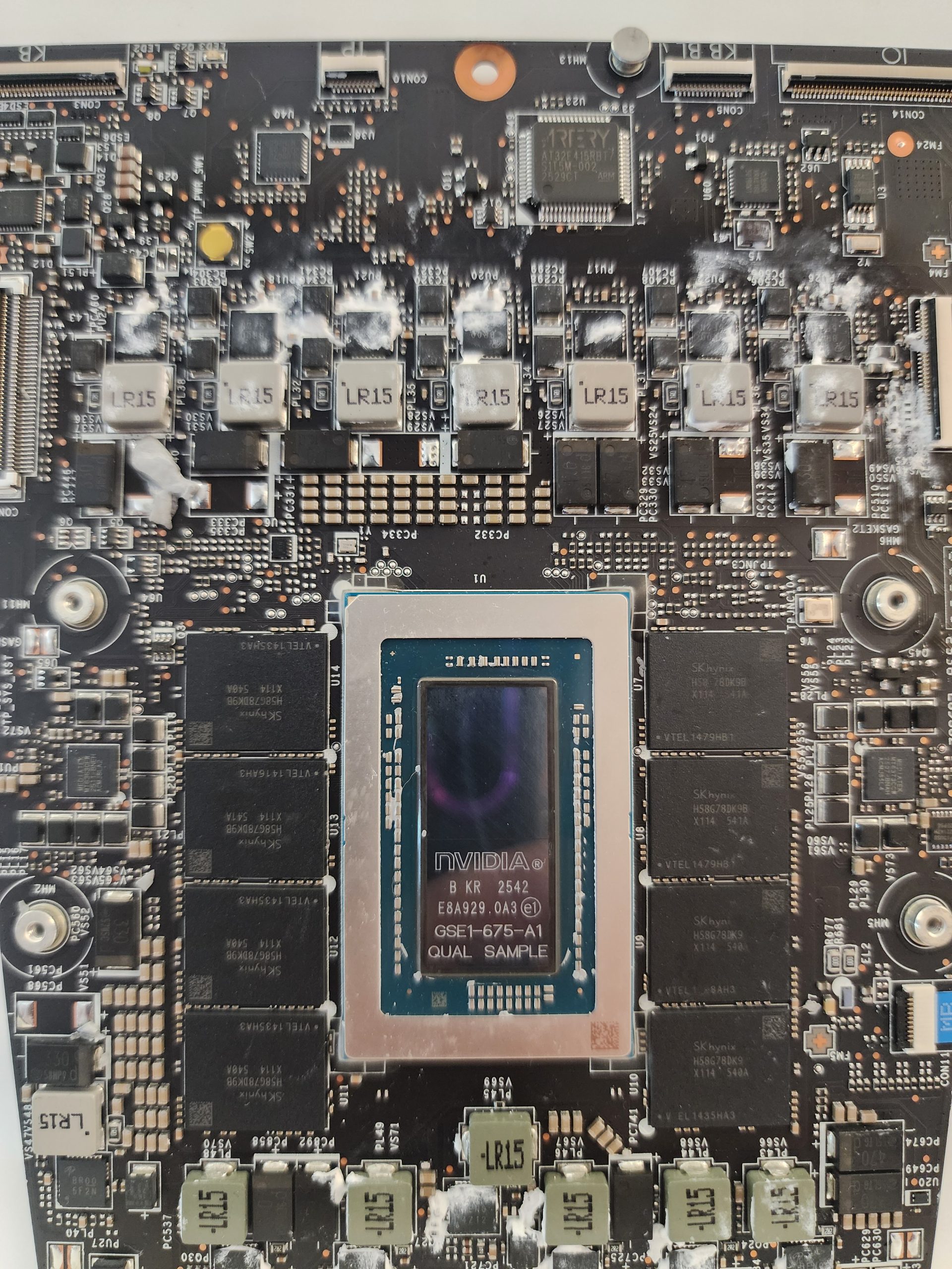 A close-up of an NVIDIA chip labeled 'GSE1-675-A1 QUAL SAMPLE' on a circuit board with multiple visible SK Hynix memory modules.