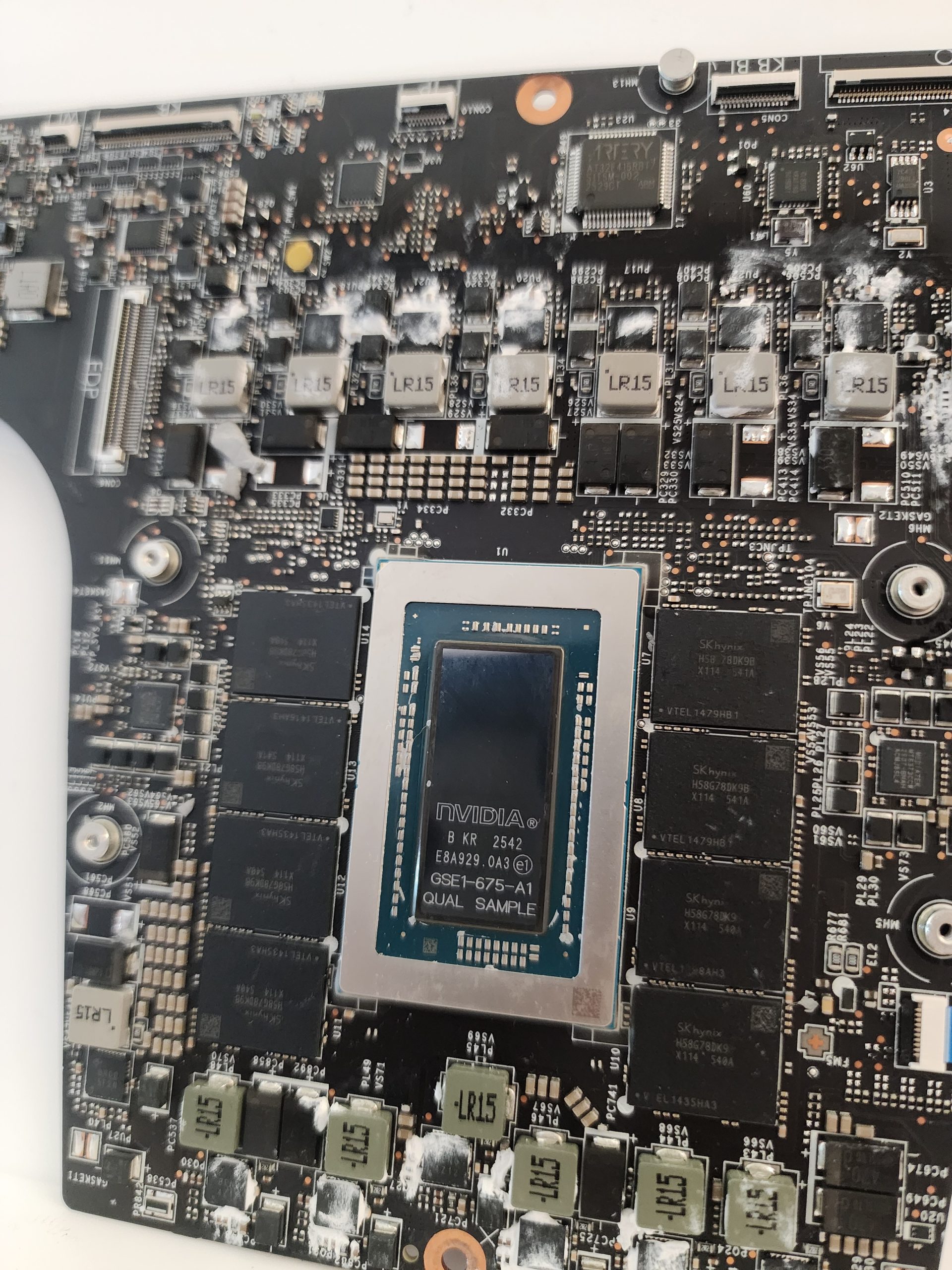 A close-up view of a motherboard featuring an NVIDIA chip labeled 'GSE-675-A1 QUAL SAMPLE' surrounded by various electronic components.