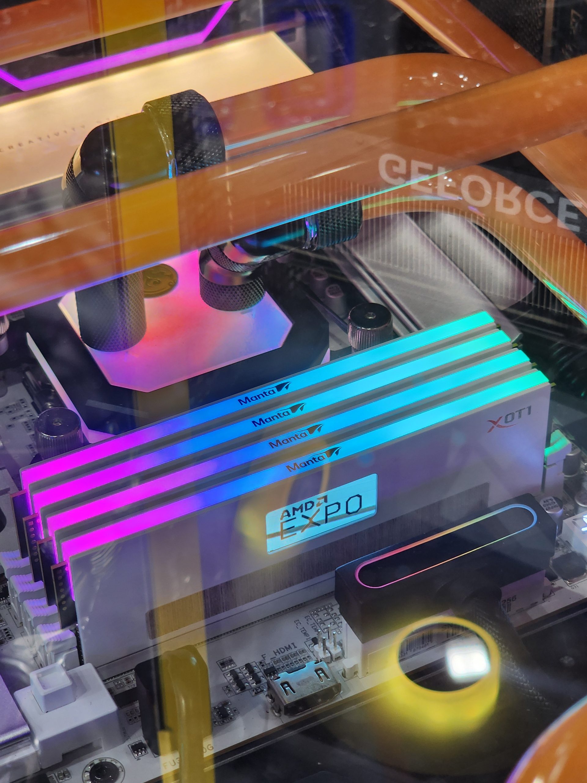 A close-up of a PC build featuring Manta RGB RAM sticks with 'AMD EXPO' visible on the motherboard.
