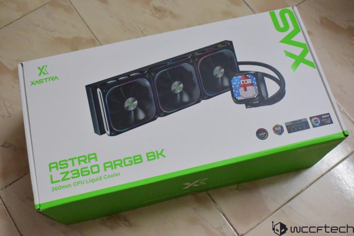A Xastra Astra LZ360 ARGB BK 360mm CPU liquid cooler box on a tiled floor, showcasing the product image and logos for compatibility with Aura Sync, RGB Fusion, Polychrome Sync, and MSI Mystic Light.