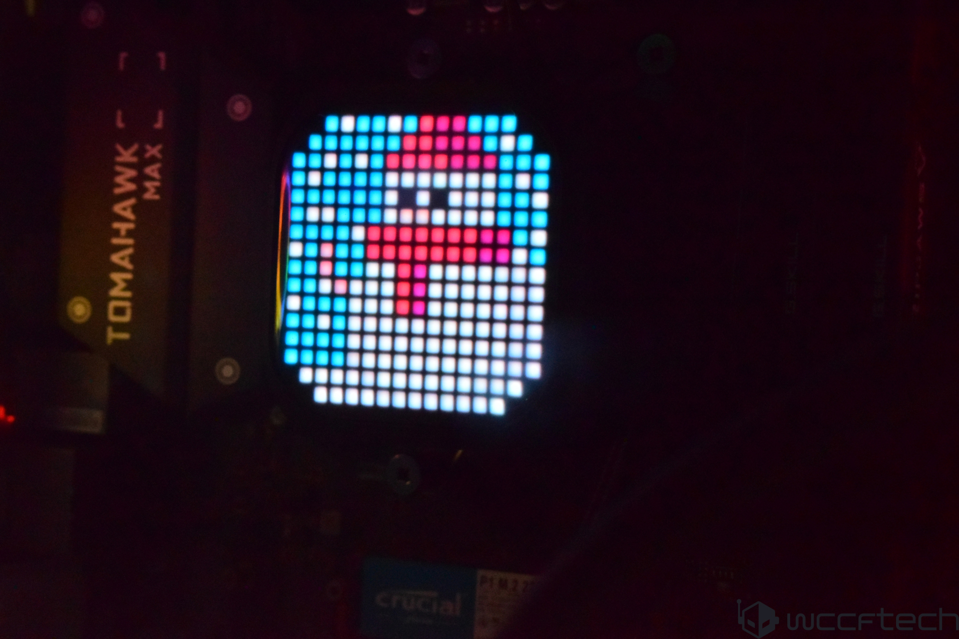 A digital display on a MSI Tomahawk Max motherboard shows a pixelated snowman graphic.