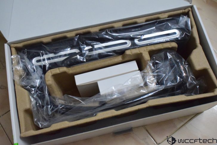 An unopened analog microphone packaged in a cardboard box with plastic wrapping visible.
