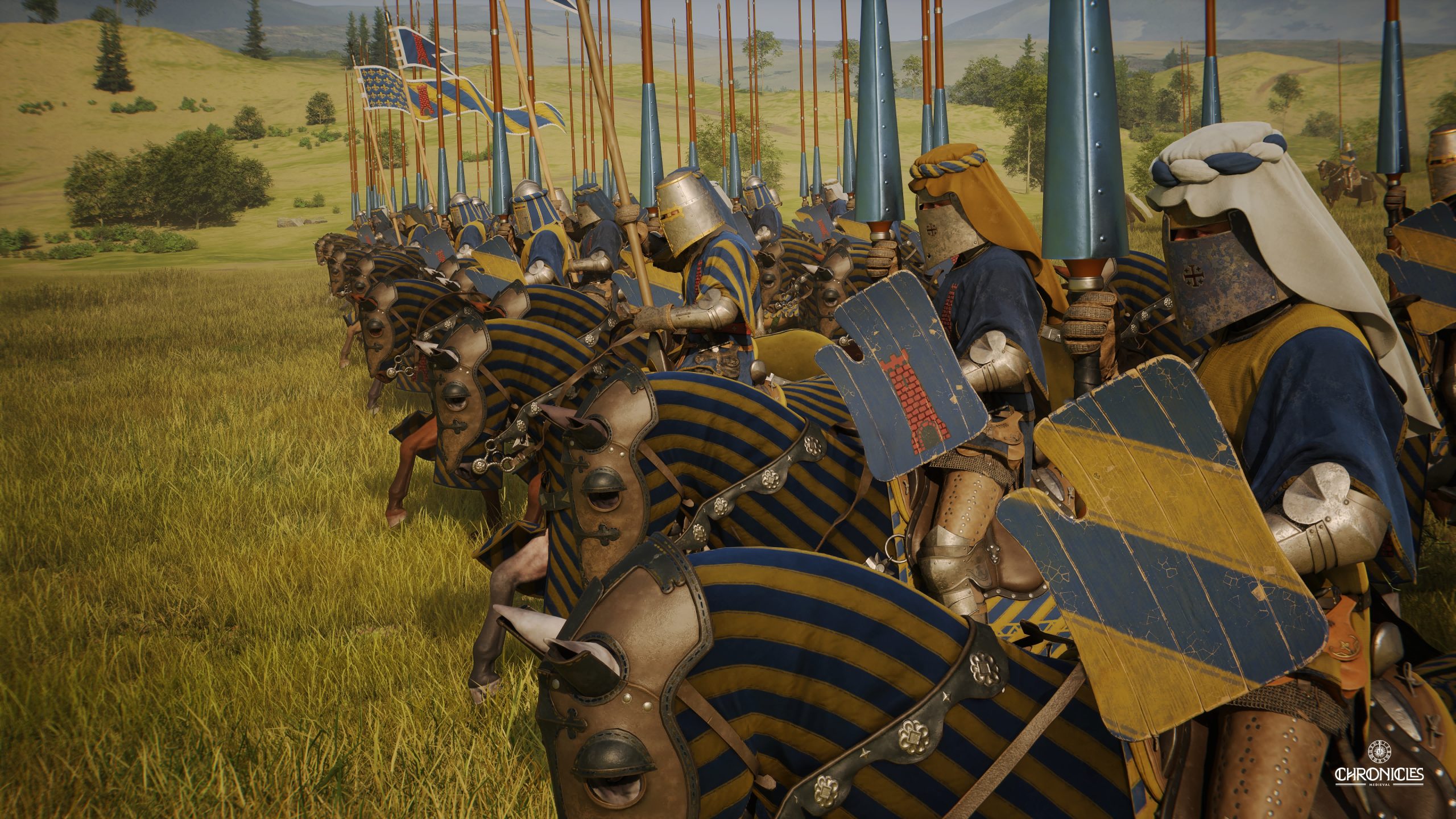 Medieval knights on horseback, wearing blue and yellow striped armor with shields and lances, prepare for battle in a grassy field in the game 'Chronicles.'