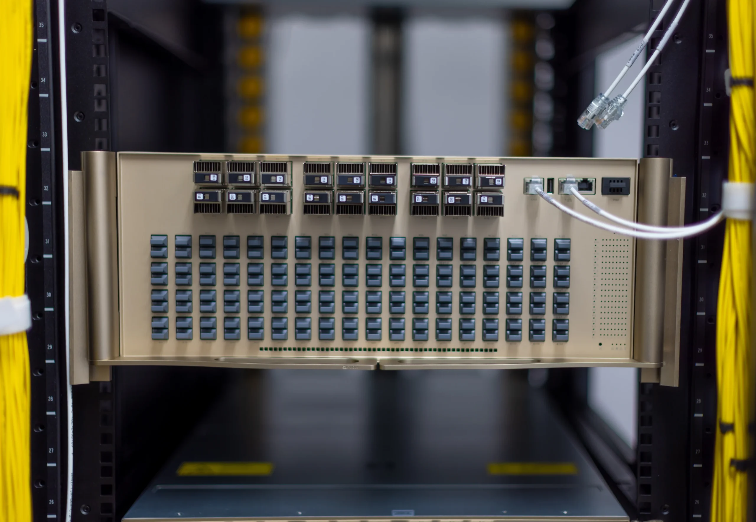 A close-up view of a server rack showing multiple network modules and two connected Ethernet cables.