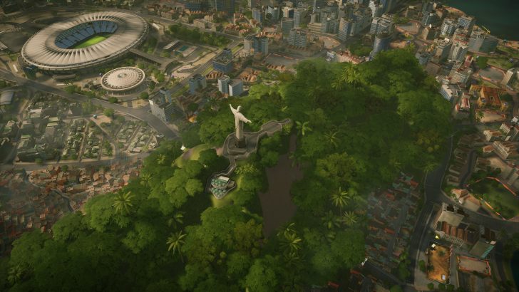 A simulated cityscape in a video game features an aerial view of a famous statue resembling Christ the Redeemer, surrounded by lush greenery, with a stadium in the background.