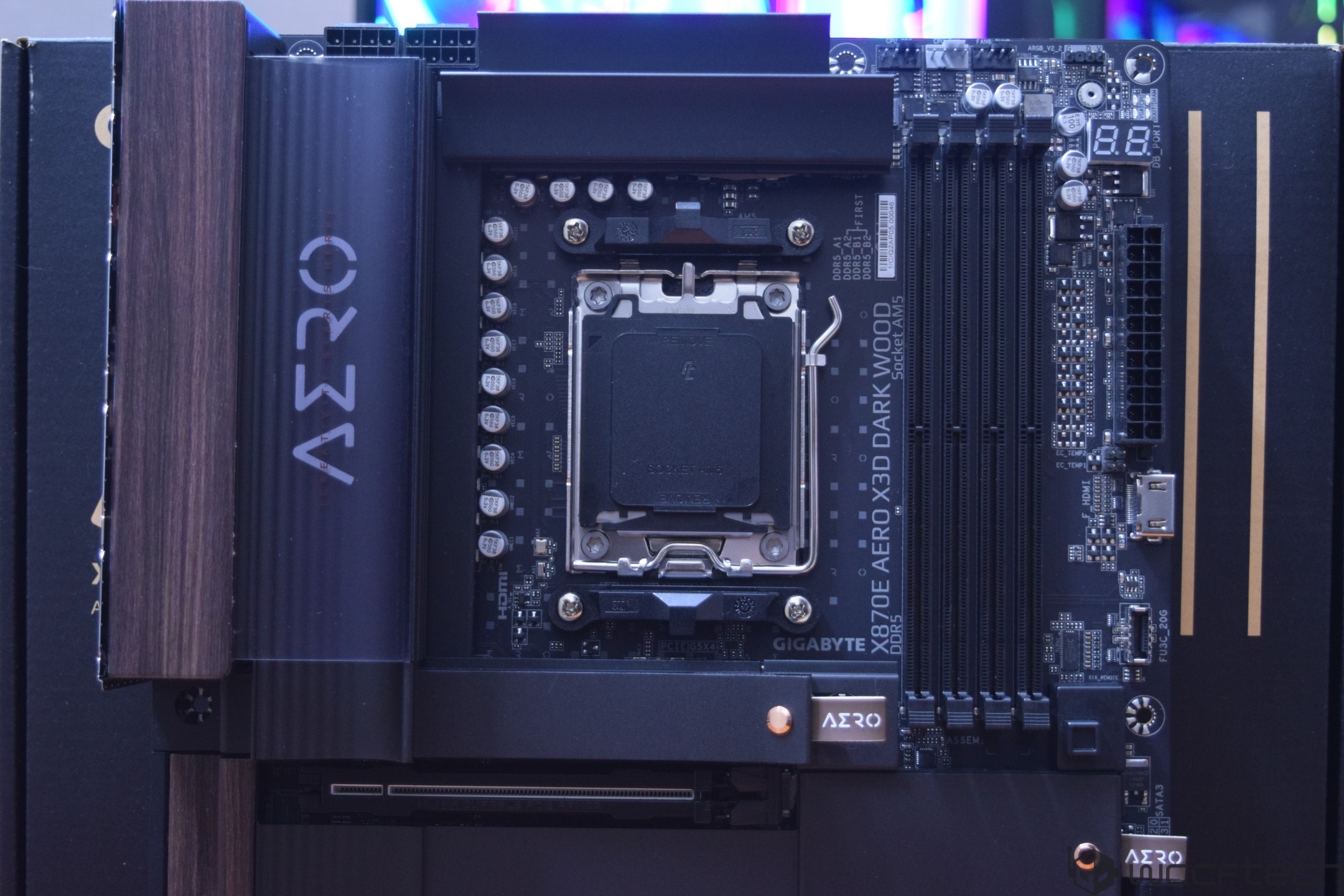 Gigabyte X670E AERO X3D DARK WOOD motherboard with visible branding and socket for AMD processors.