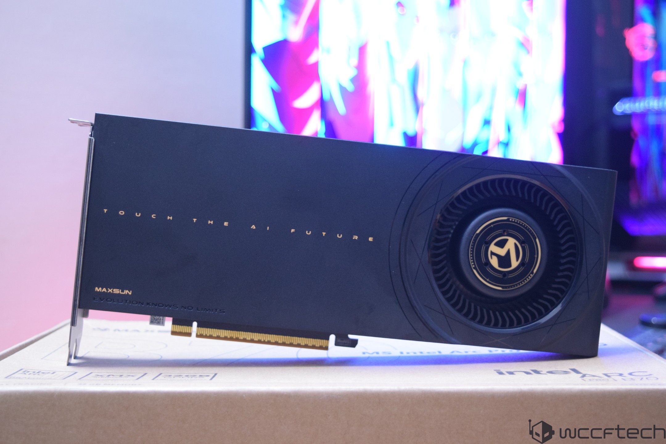 A MaxSun graphics card with the text 'Touch the AI Future' is resting on an Intel Arc packaging box.