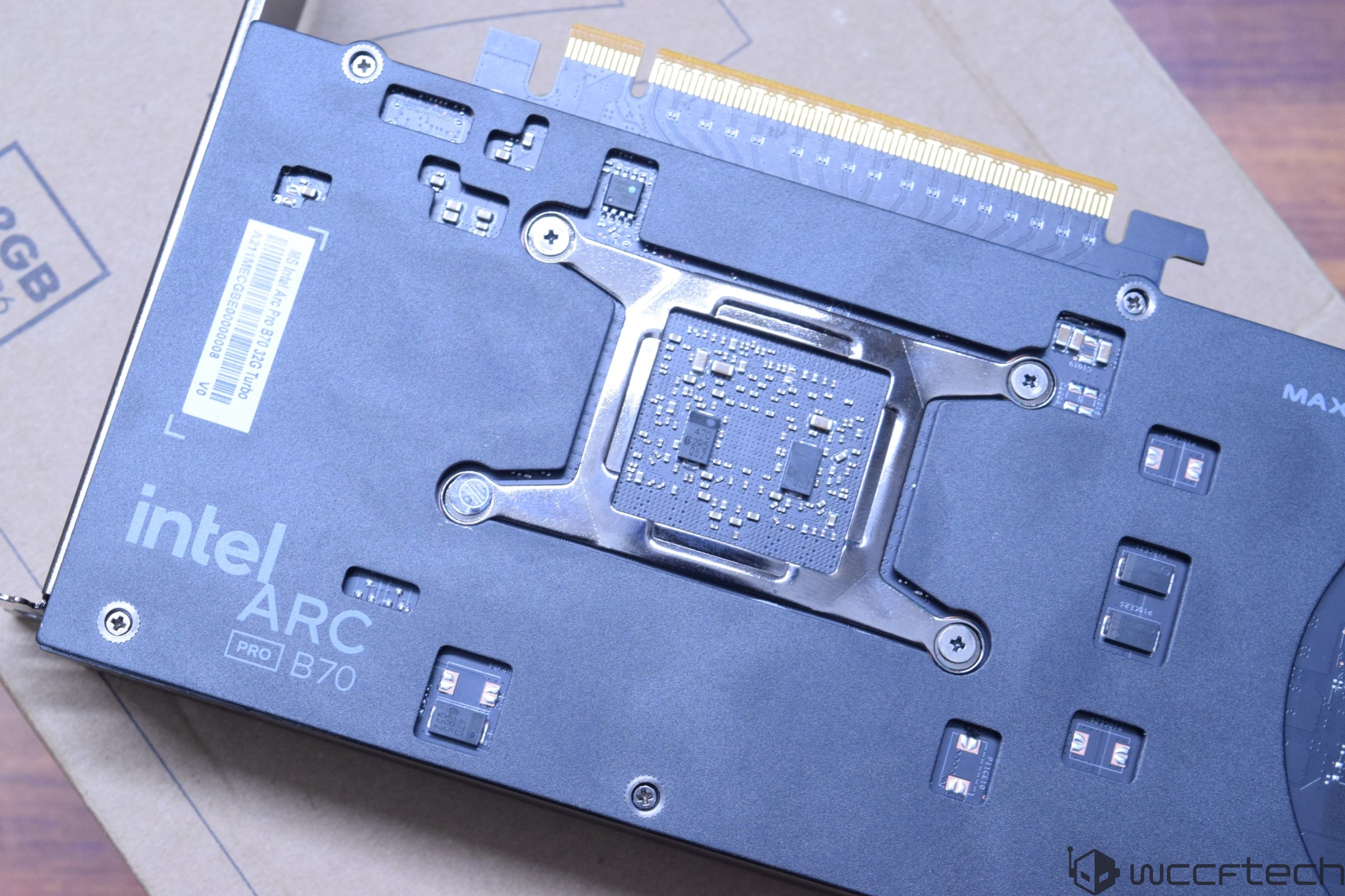 The image shows the back side of an Intel Arc Pro B70 graphics card with visible electronic components and a PCIe connector.