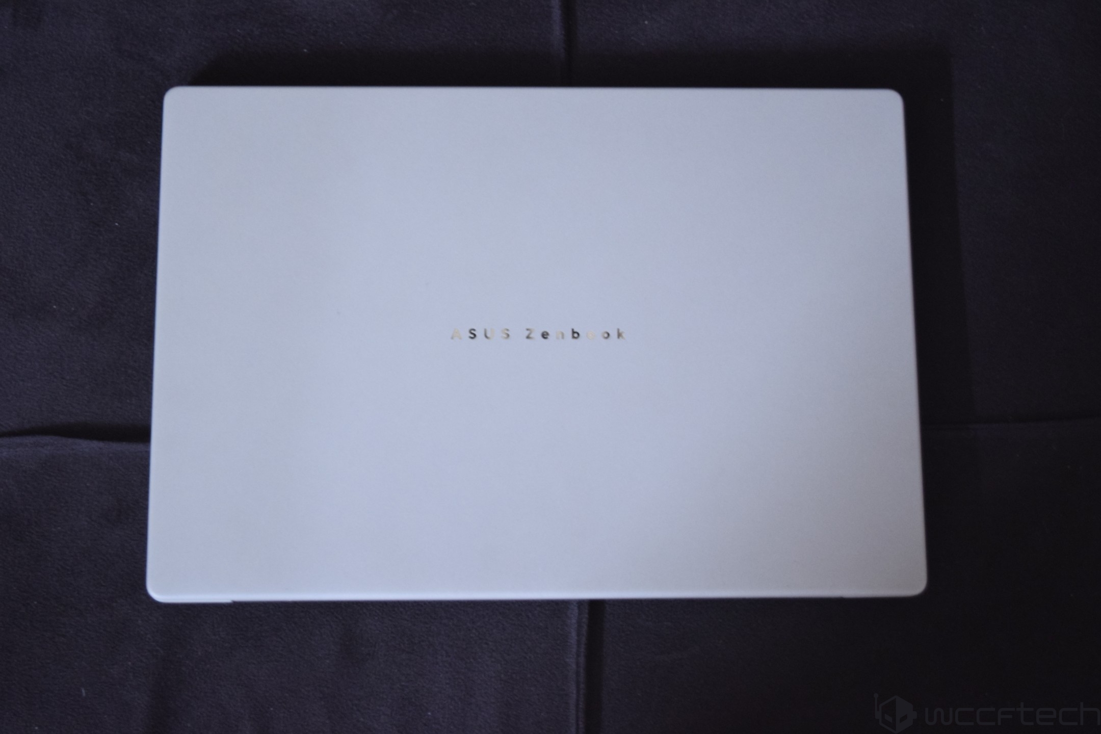 A closed ASUS Zenbook laptop with the logo 'ASUS Zenbook' centered on the lid.